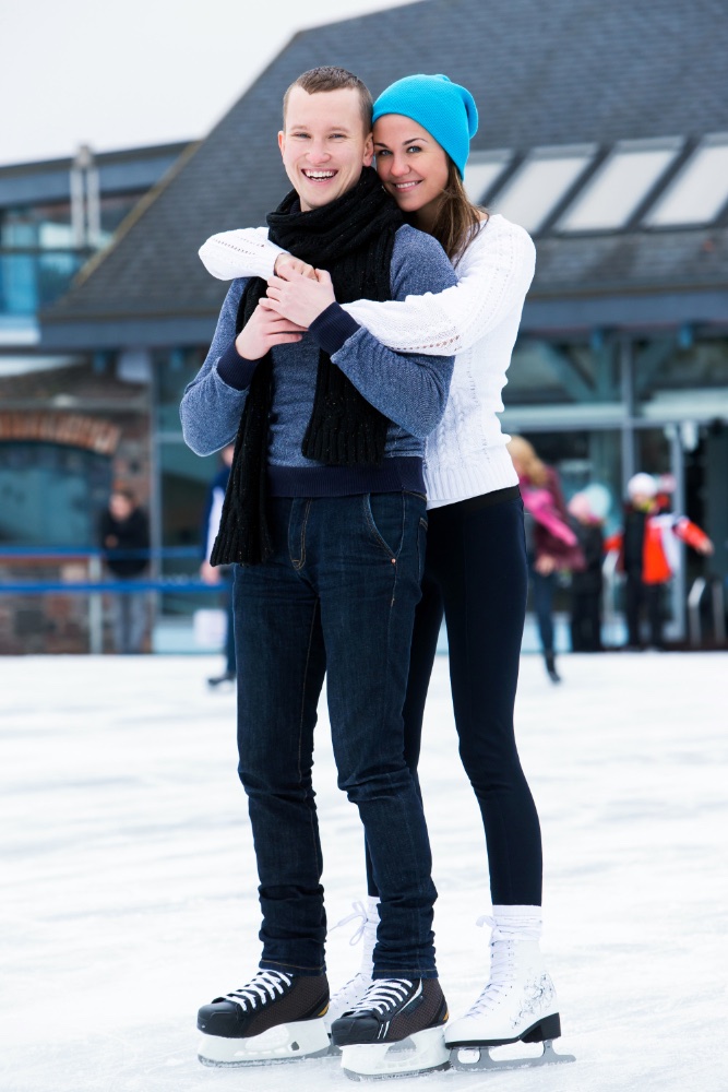 An image of a man and woman on ice skates.