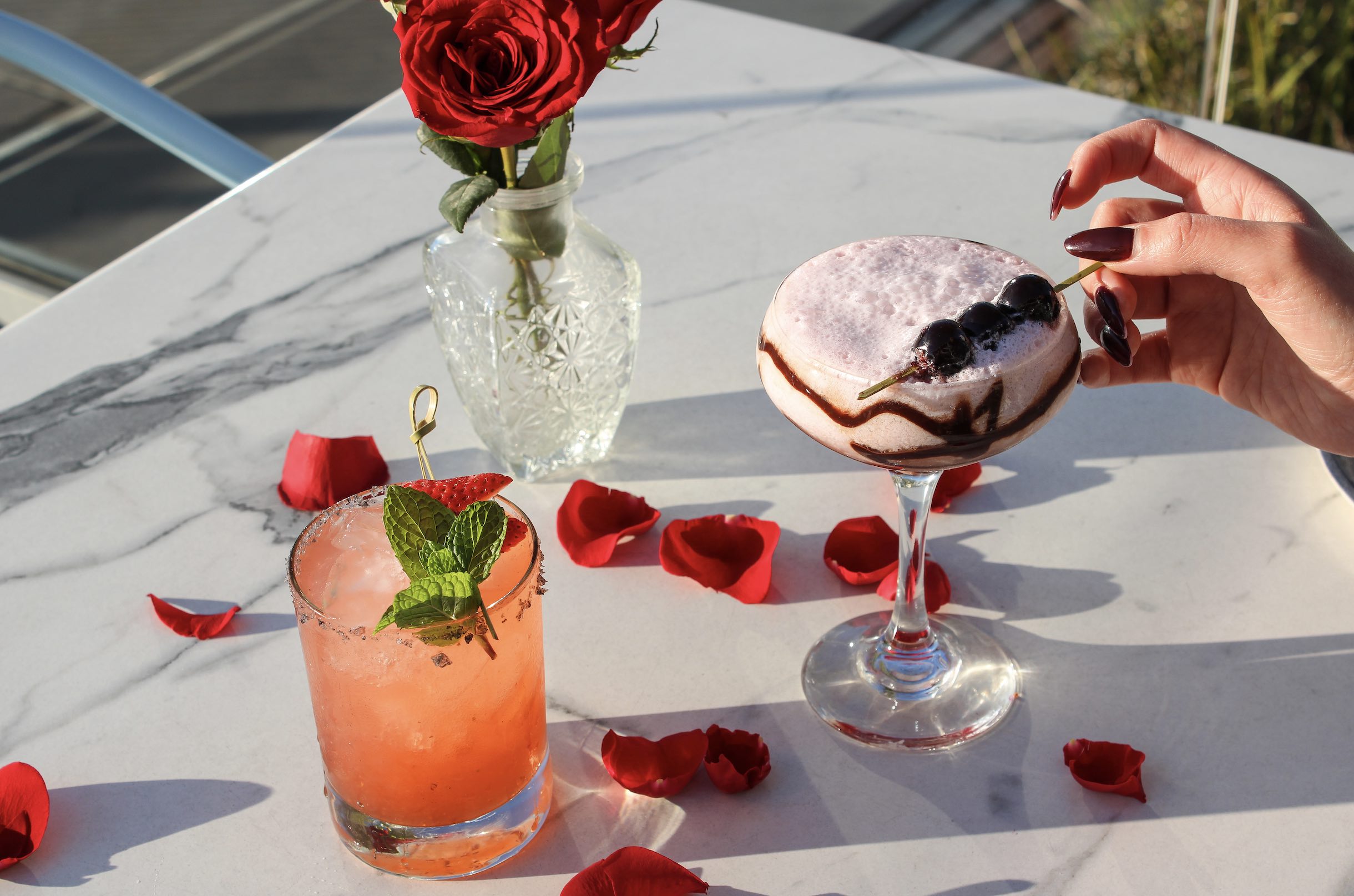 An image of cocktails and rose petals at SALT.