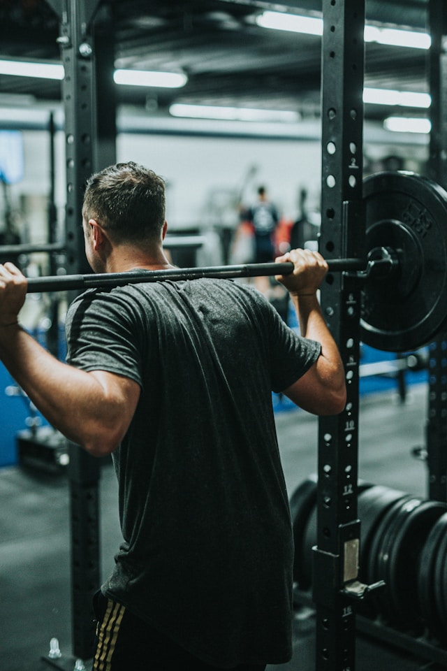 An image of a man doing squats at the gym.