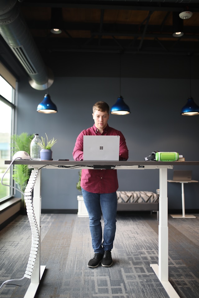 An image of a man at a standing desk.