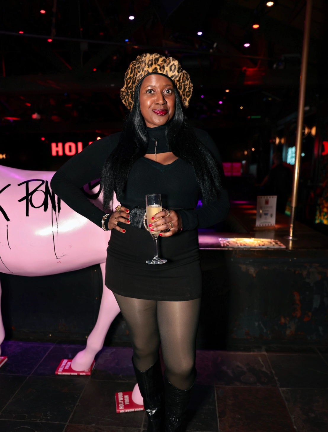 An image of Lifestyle blogger Ariel posing in front of the Pink Pony Club mascot at the book party for Hollywood Virgin