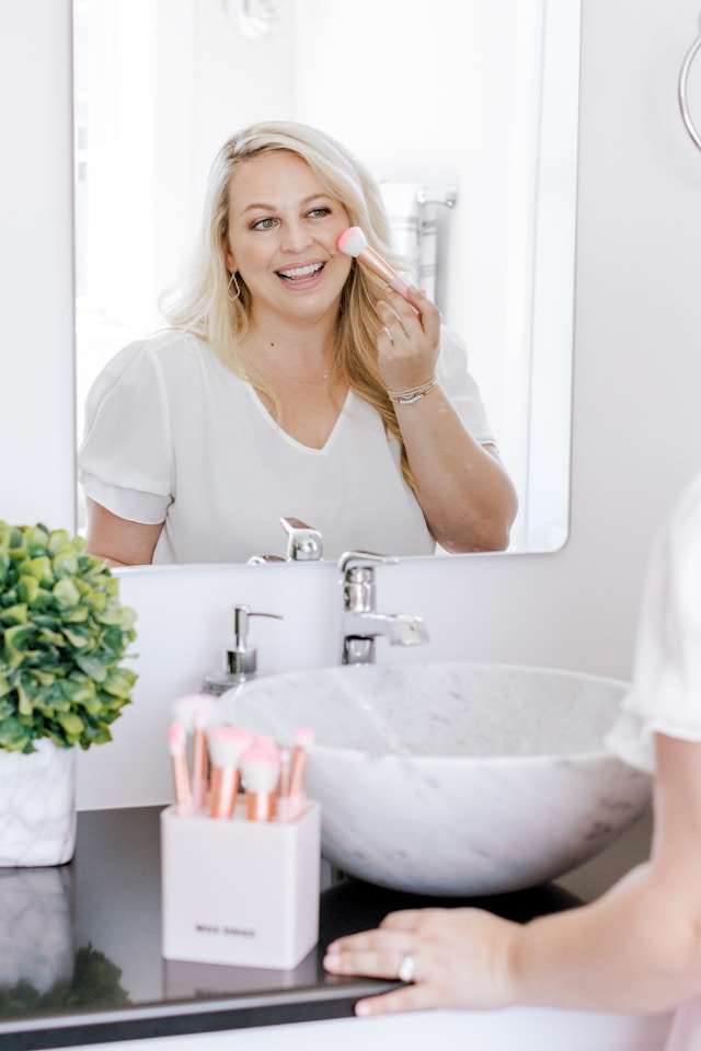 An image of a woman doing her makeup.