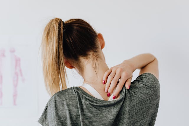 An image of a woman with neck and back pain.