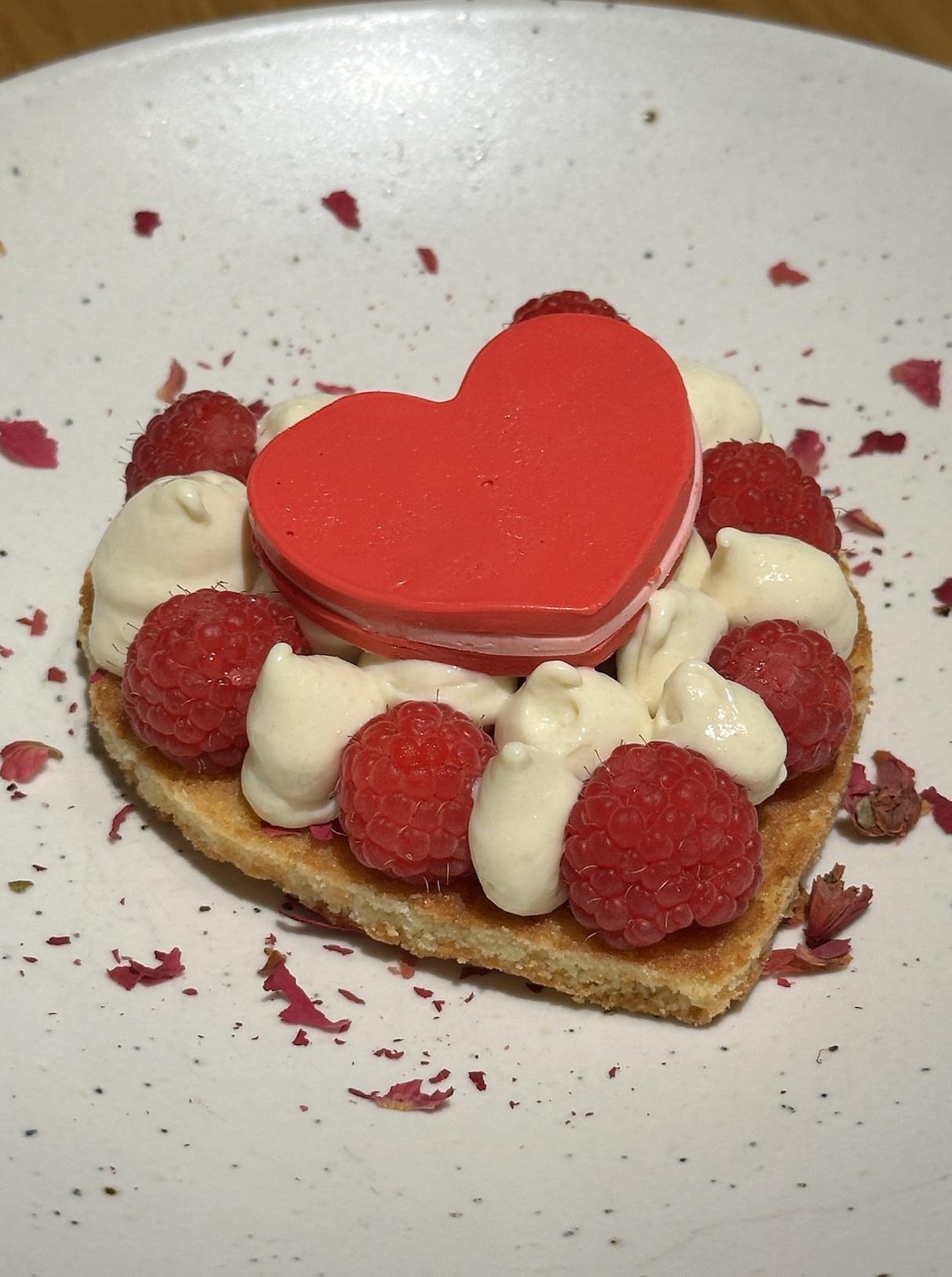 An image of the Sweet Heart dessert, a basque shortbread with ginger vanilla crémeux and a raspberry heart at Teleferic.