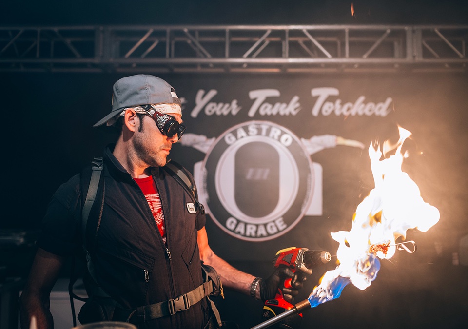 An image of a member of the Gastro Garage with a blow torch.