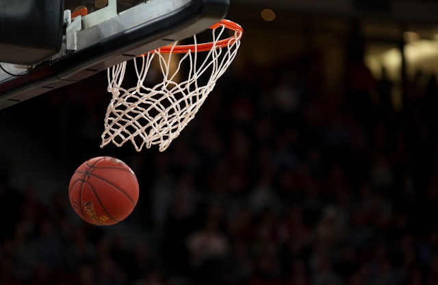 An image of a basketball and basketball net.