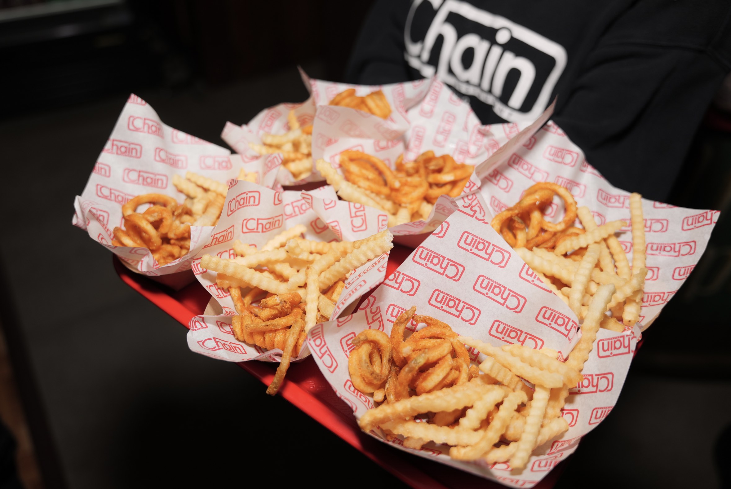 An image of several basket of French Fries.