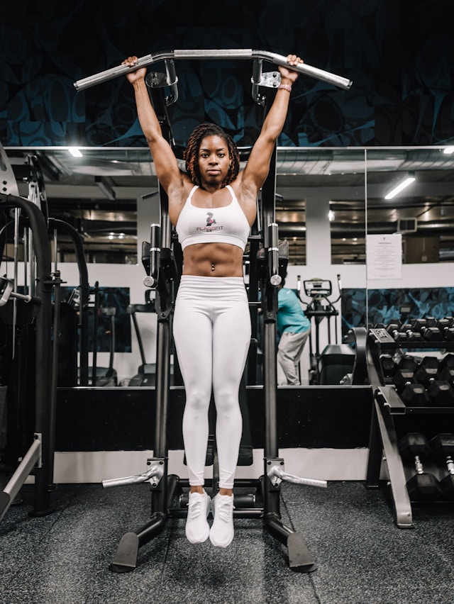 An image of a black woman working out at a gym.