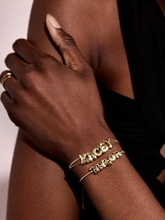 An image of a woman wearing Bauble Bar jewelry.