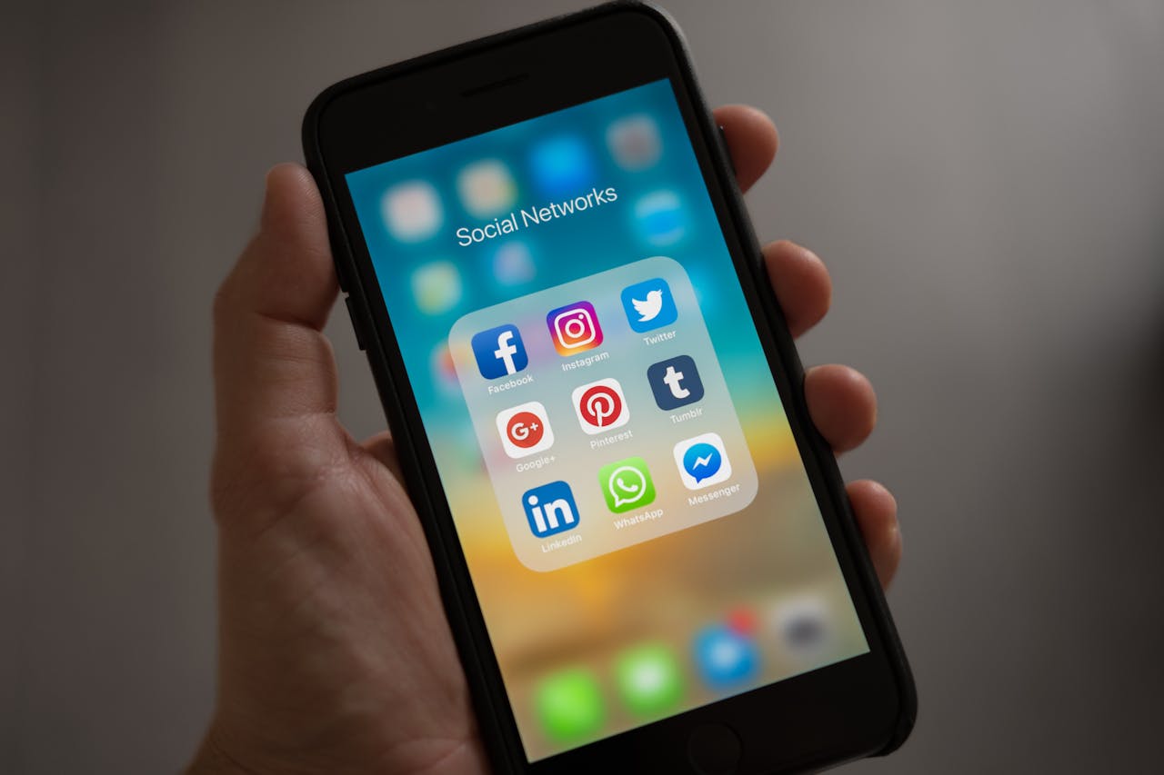 An image of a phone with social media icons on it.