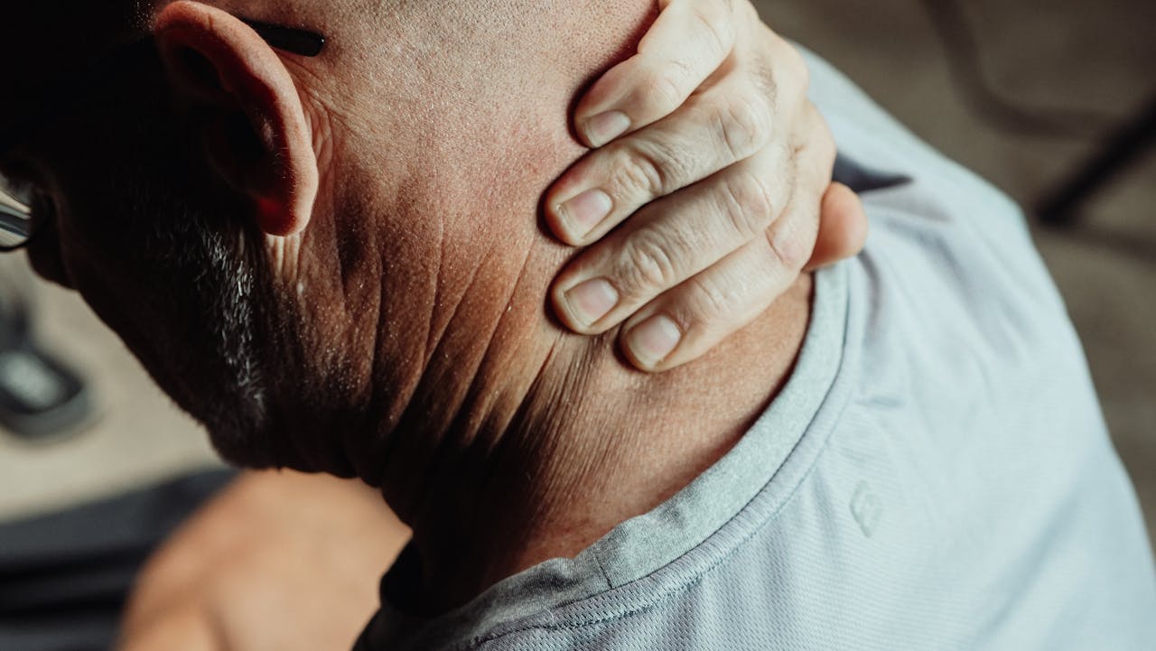 An image of a man dealing with neck pain.