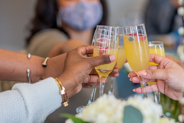 A group of people drinking mimosas for brunch.