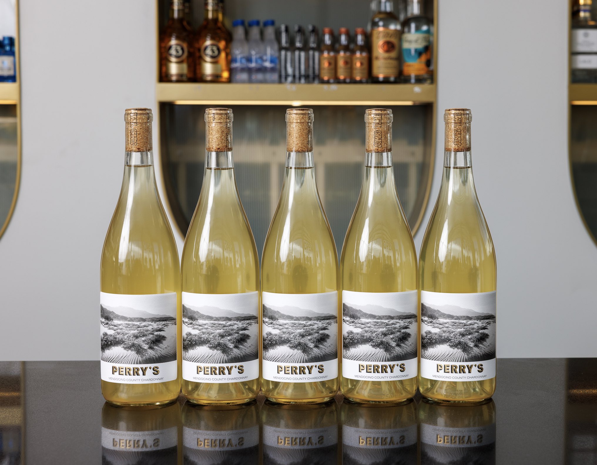 An image of 5 bottles of Perry's Fine Wines & Liquors new Chardonnay.