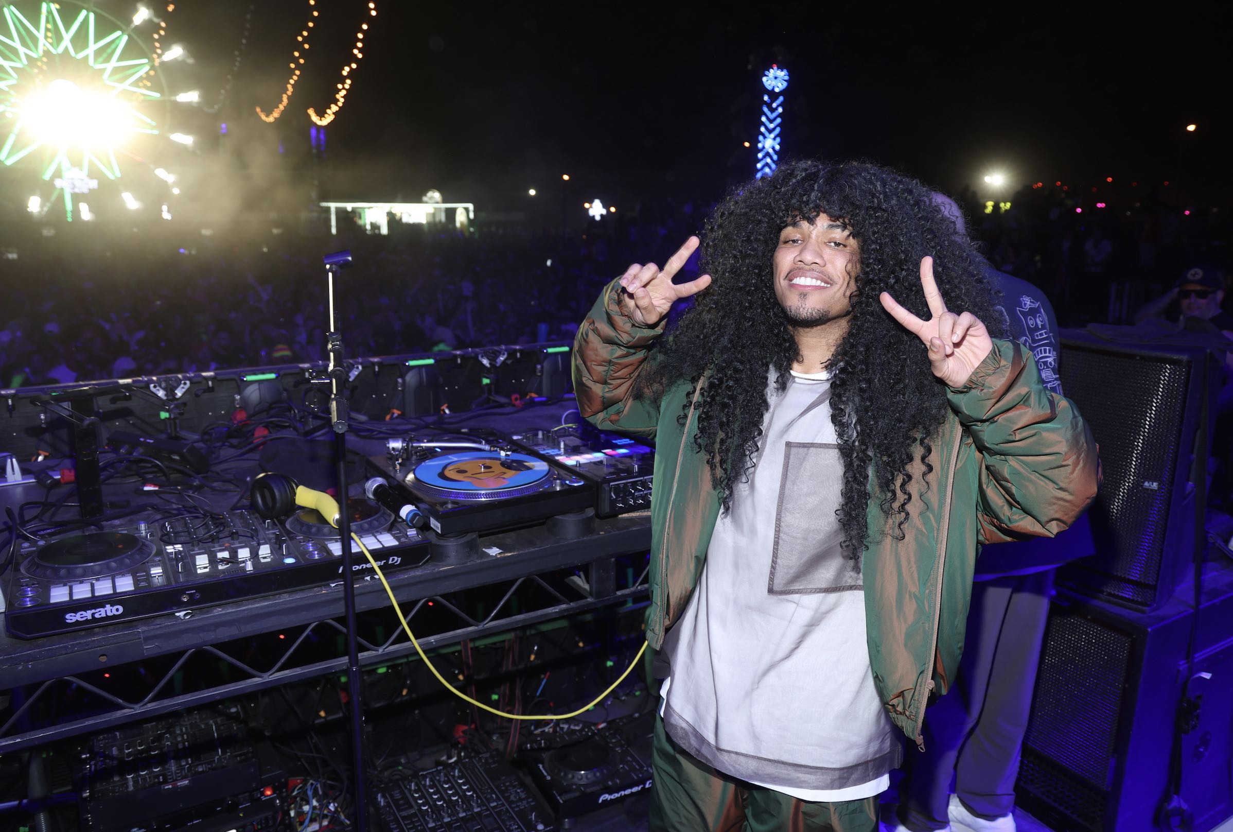 An image of 8x Grammy Award-winning artist Anderson .Paak in his vinyl-spinning alter ego, DJ Pee .Wee entertaining the Neon Carnival crowd.