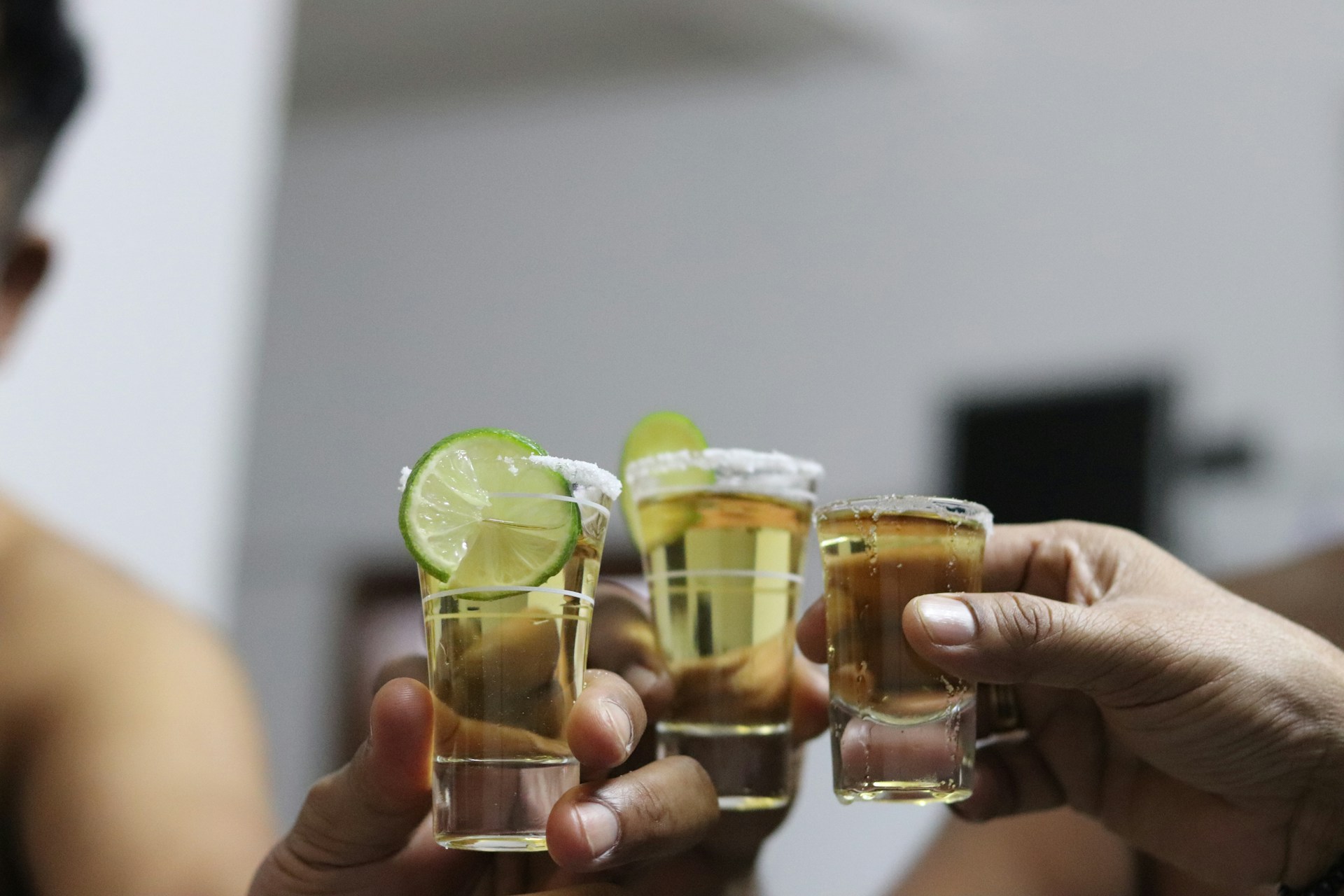 An image of people doing shots of tequila.