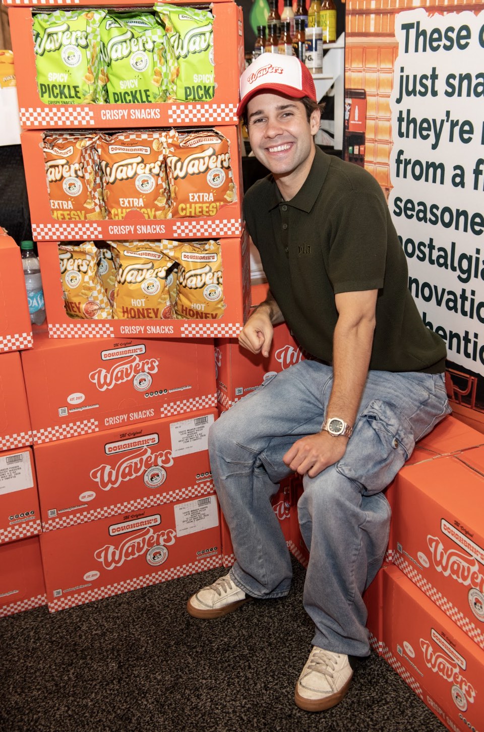 An image of David Dobrik sitting with his Wavers at the Sweet and Snacks Expo.