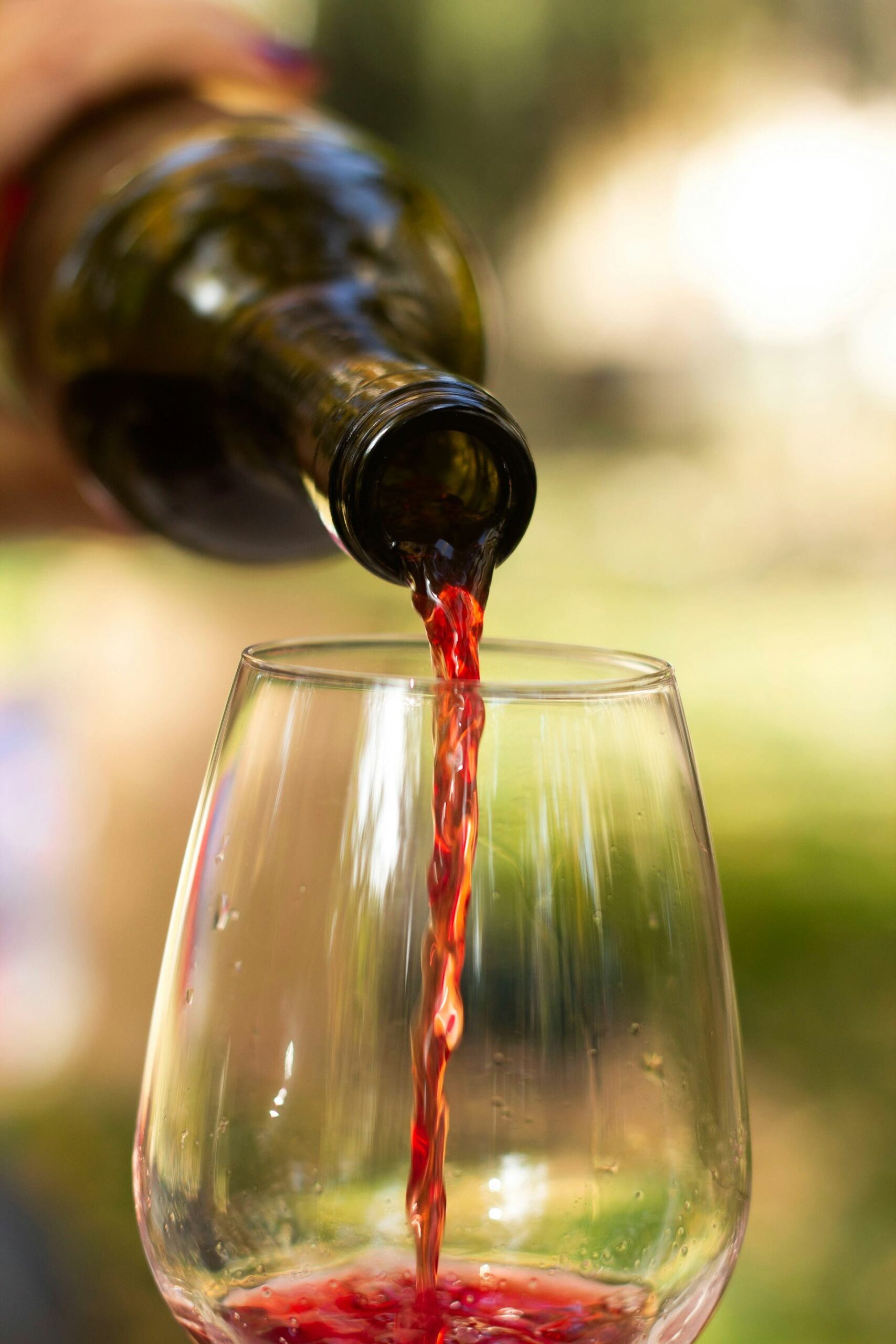An image of someone pouring a wine bottle.
