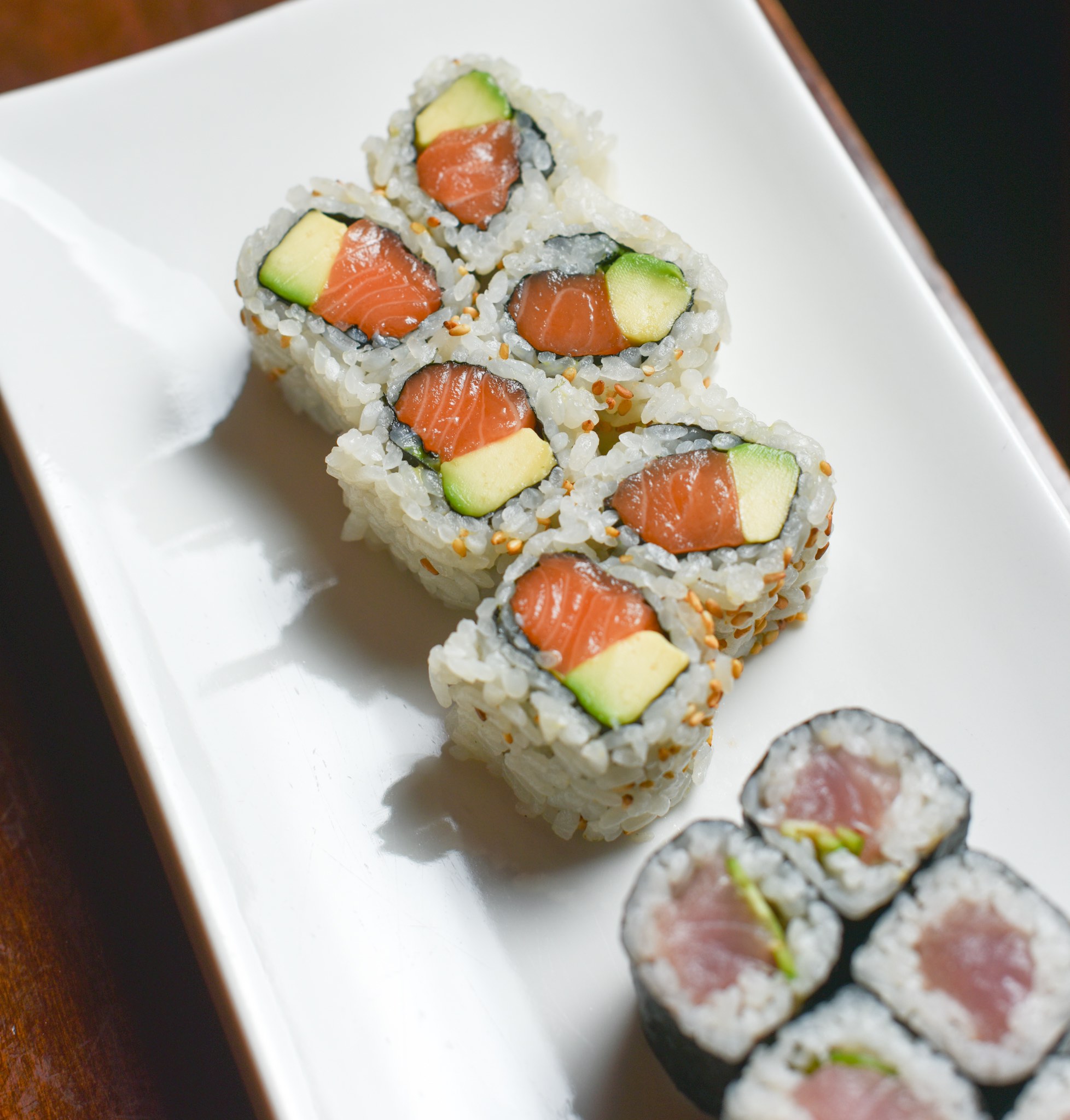 A close up image of two sushi rolls.