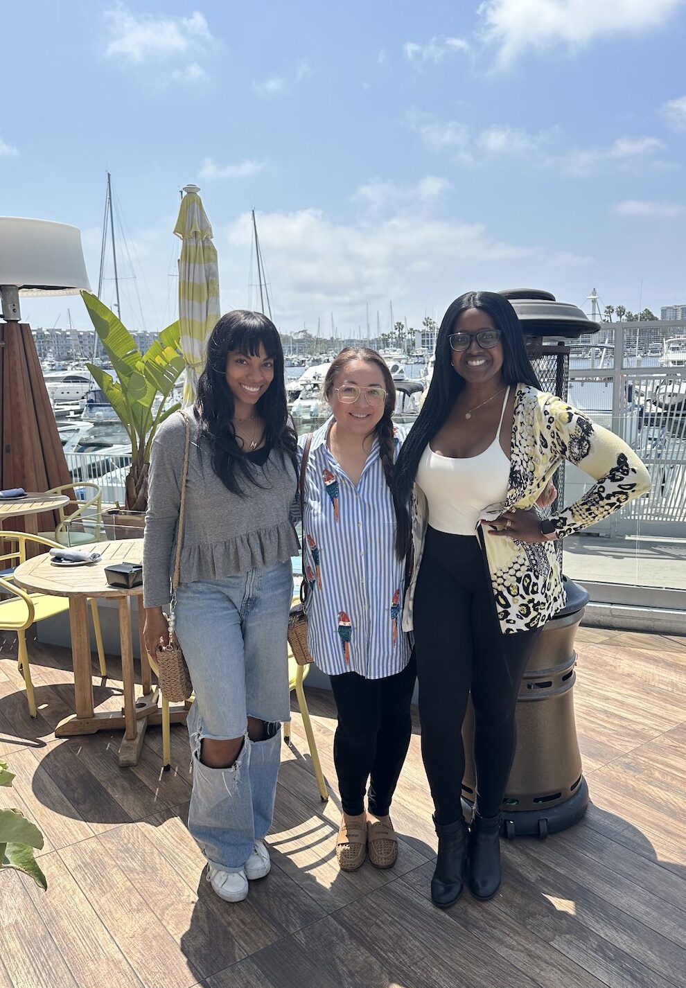 An image of lifestyle blogger Ariel with two other writers at the marina.