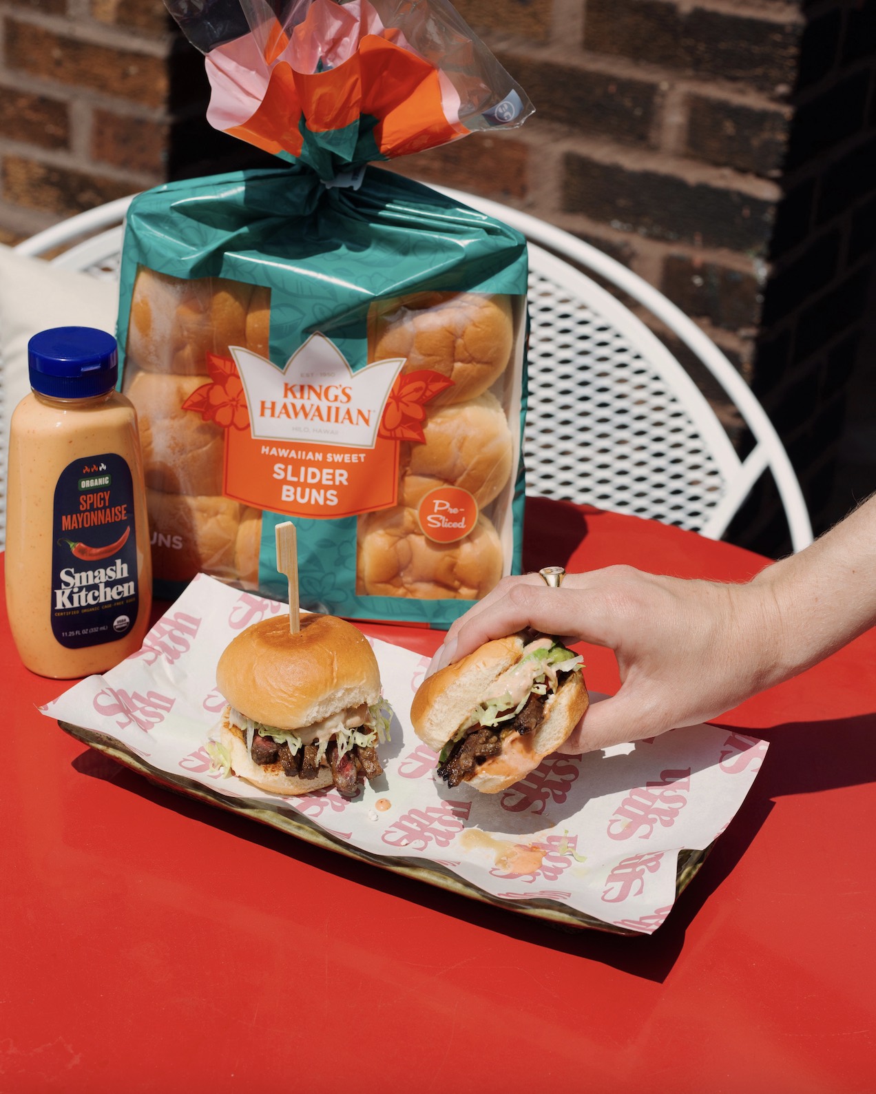 An image of  burger with Kings Hawaiian roles and Smash Kitchen mustard.