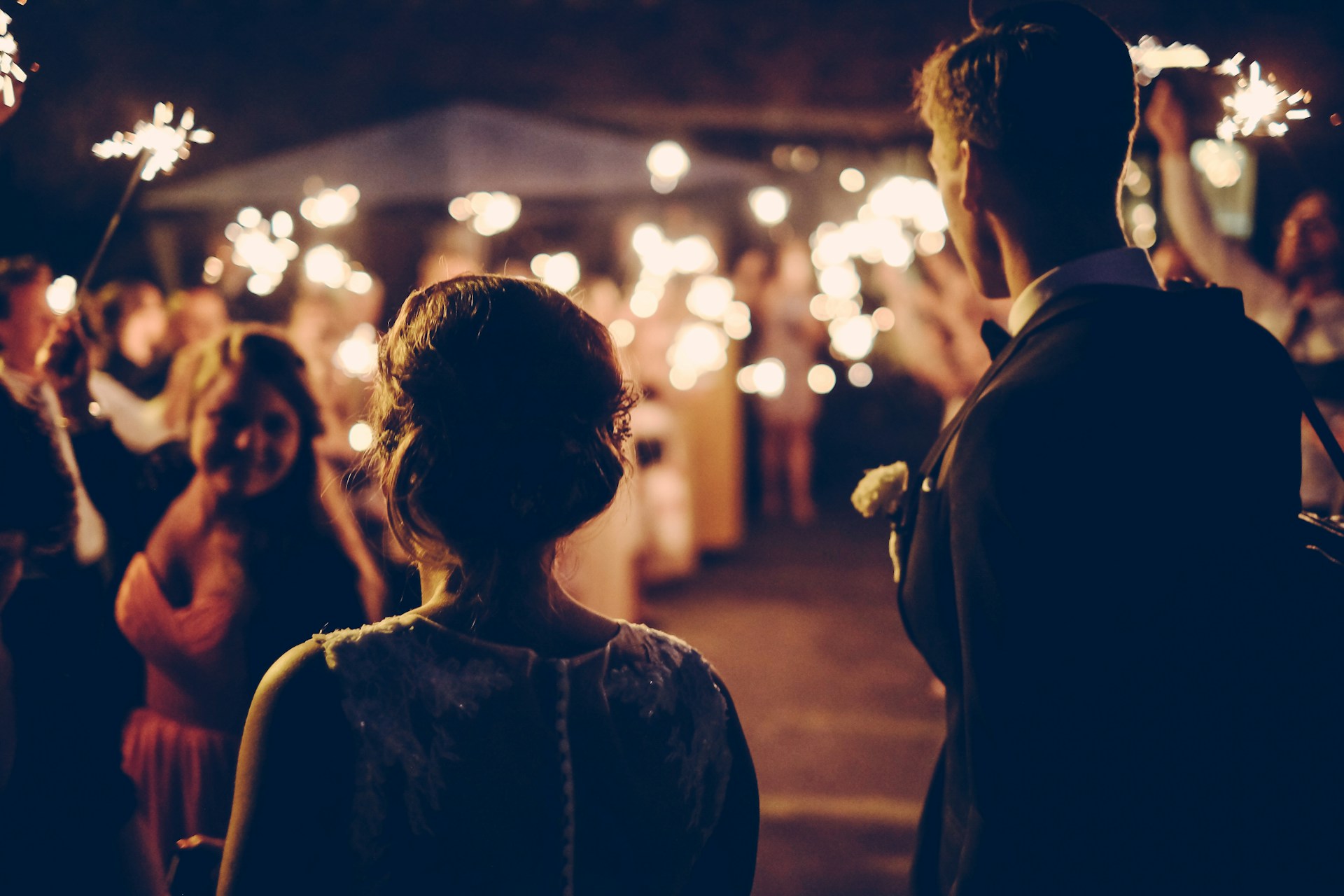 An image of a couple entering their wedding reception.