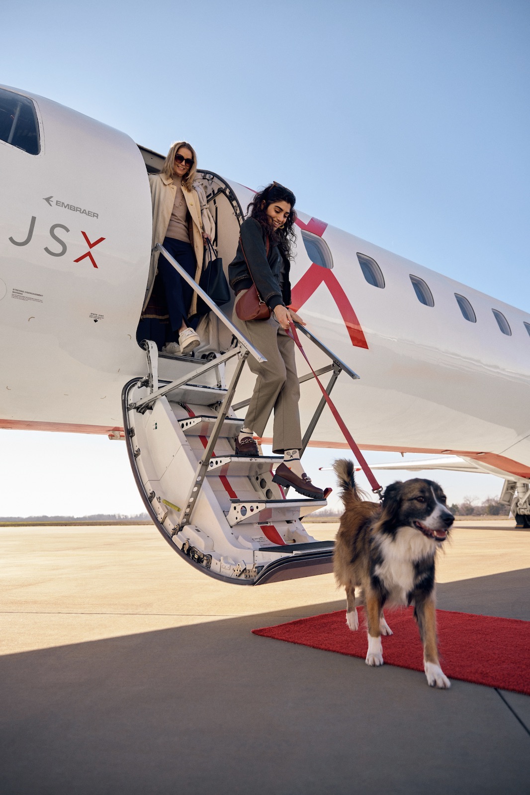 An image of two women deboarding a JSX jet.