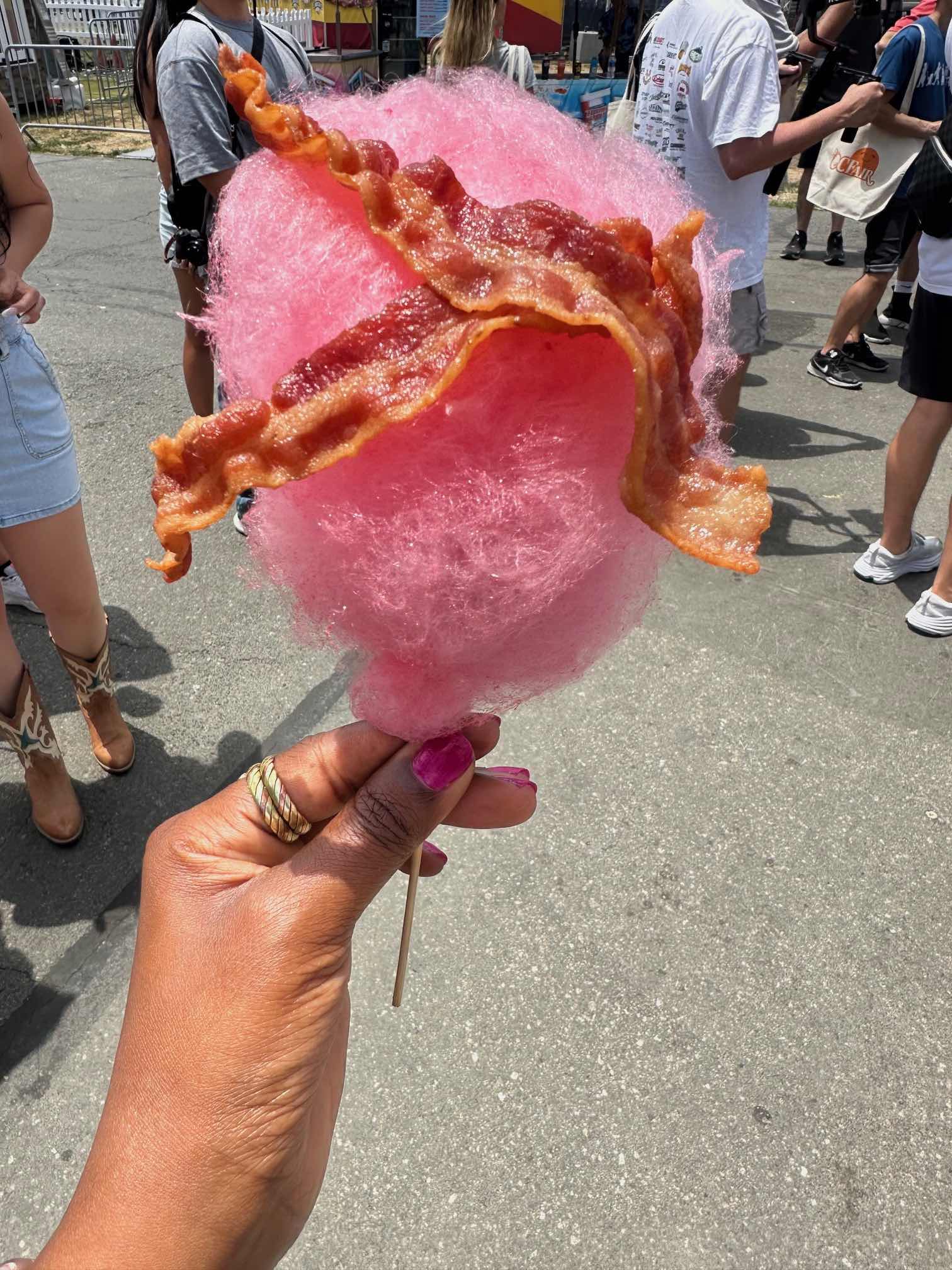 An image of someone holding a Cotton-Candy Wrapped Bacon.