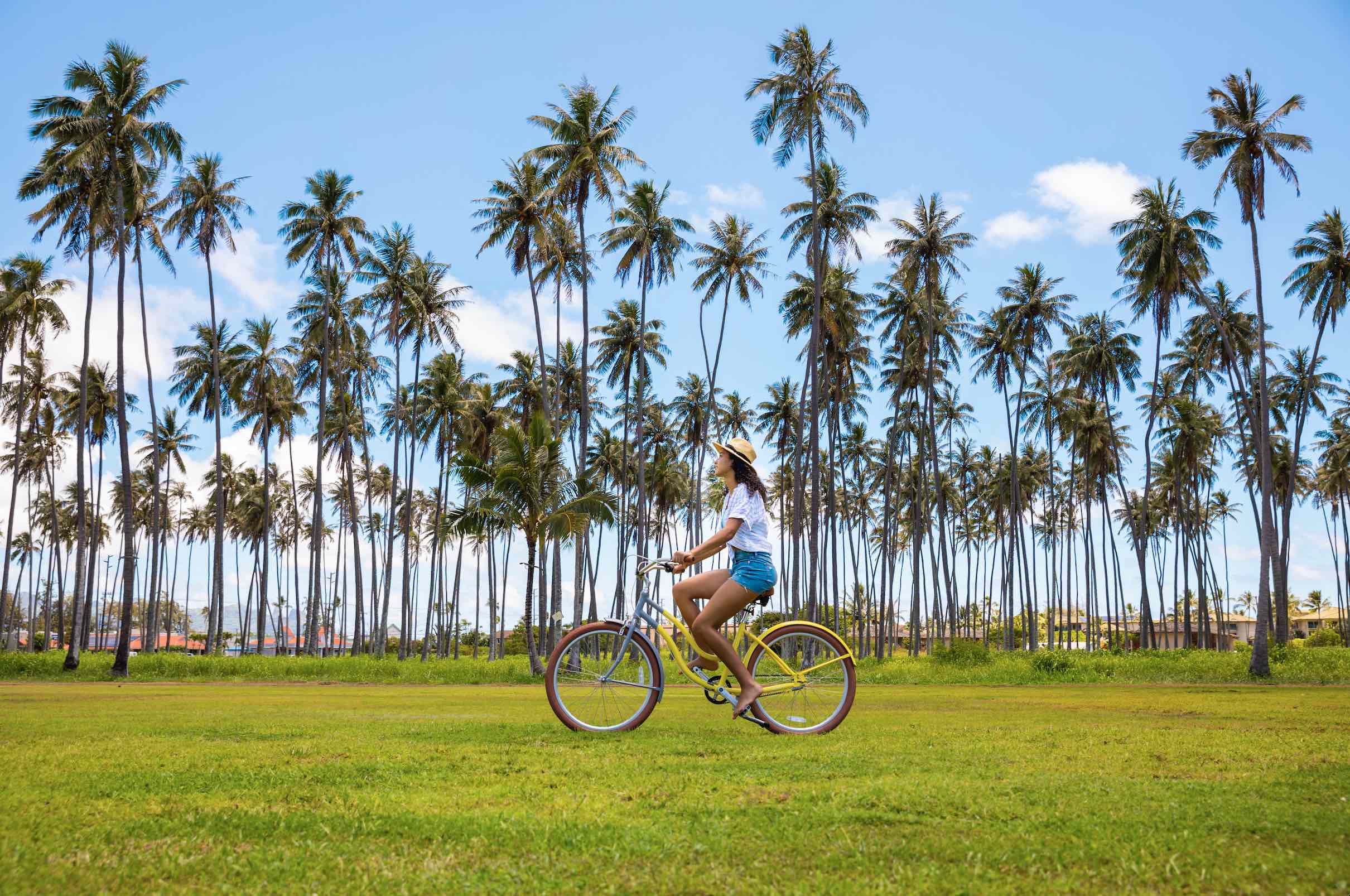 An image of a woman riding a bike at the Sheraton Kauai Coconut Beach Resort