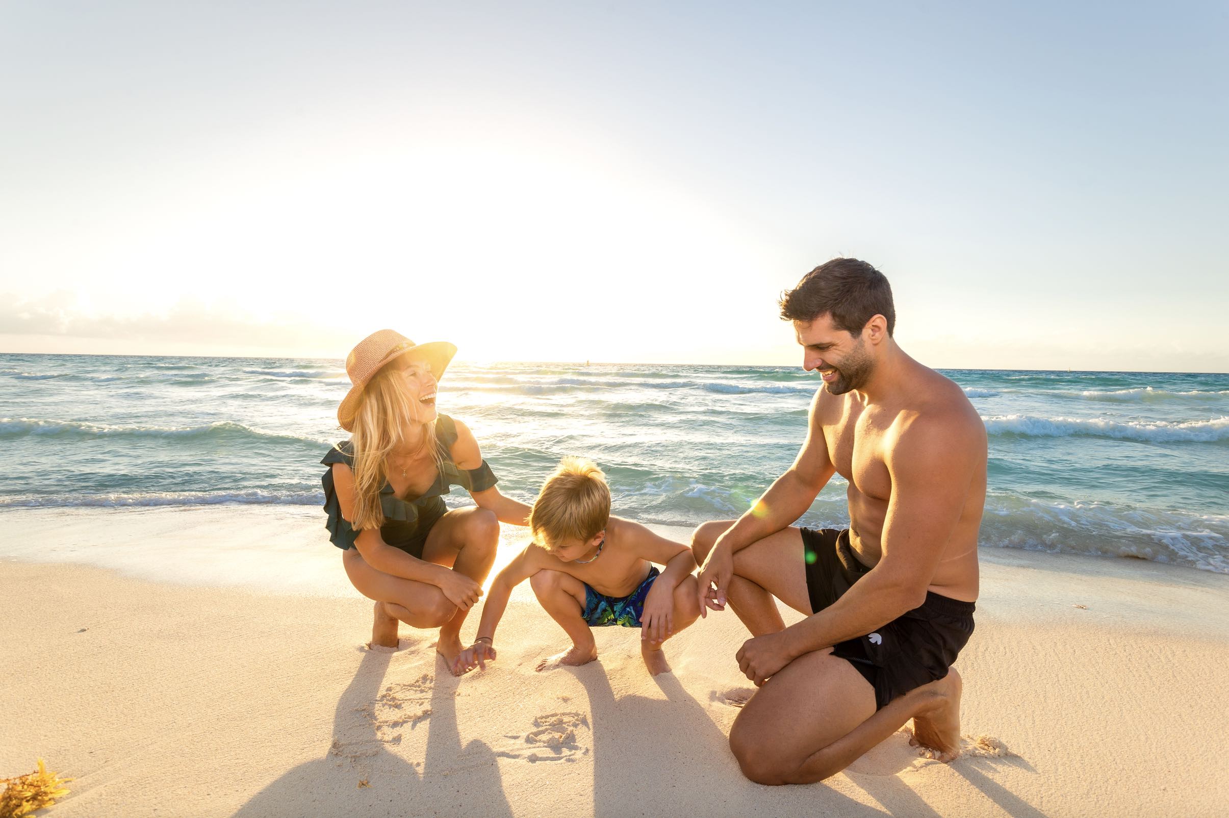 An image of a family on the beach of Sandos Playacar
