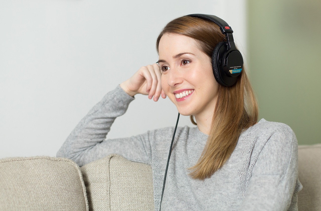 An image of a woman listening to a podcast.
