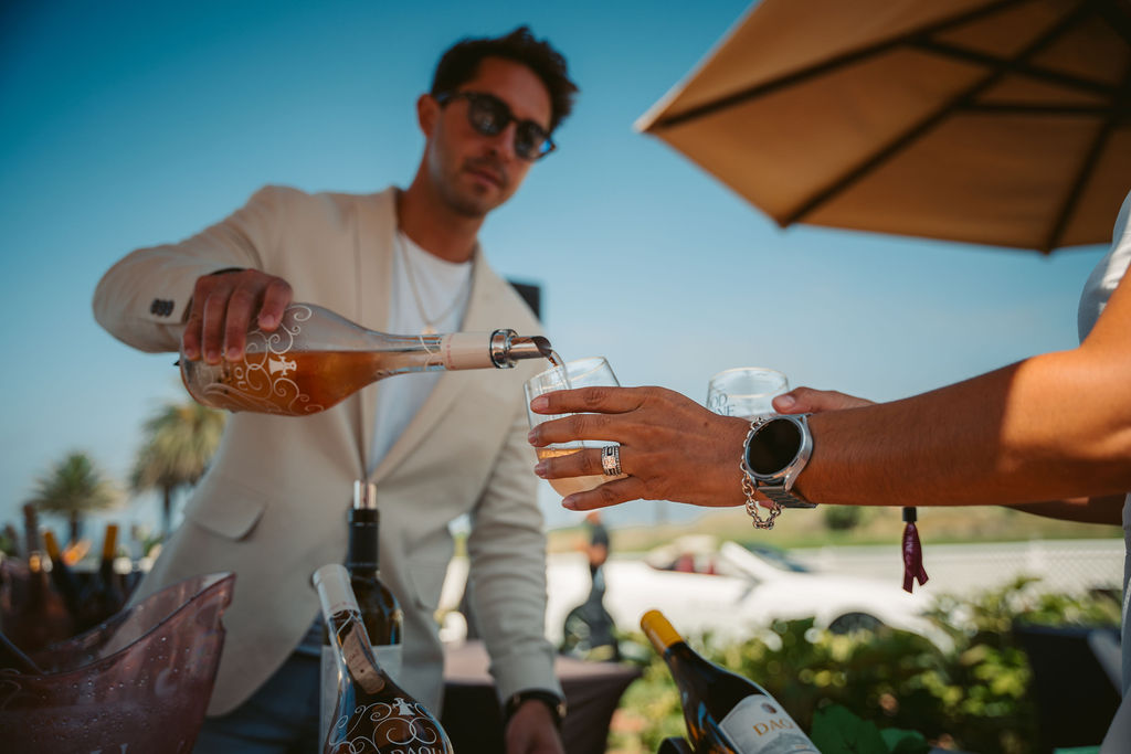 An image of a wine vendor giving out a glass of wine at Terranea Resort's signature Food & Wine Festival from 2024.