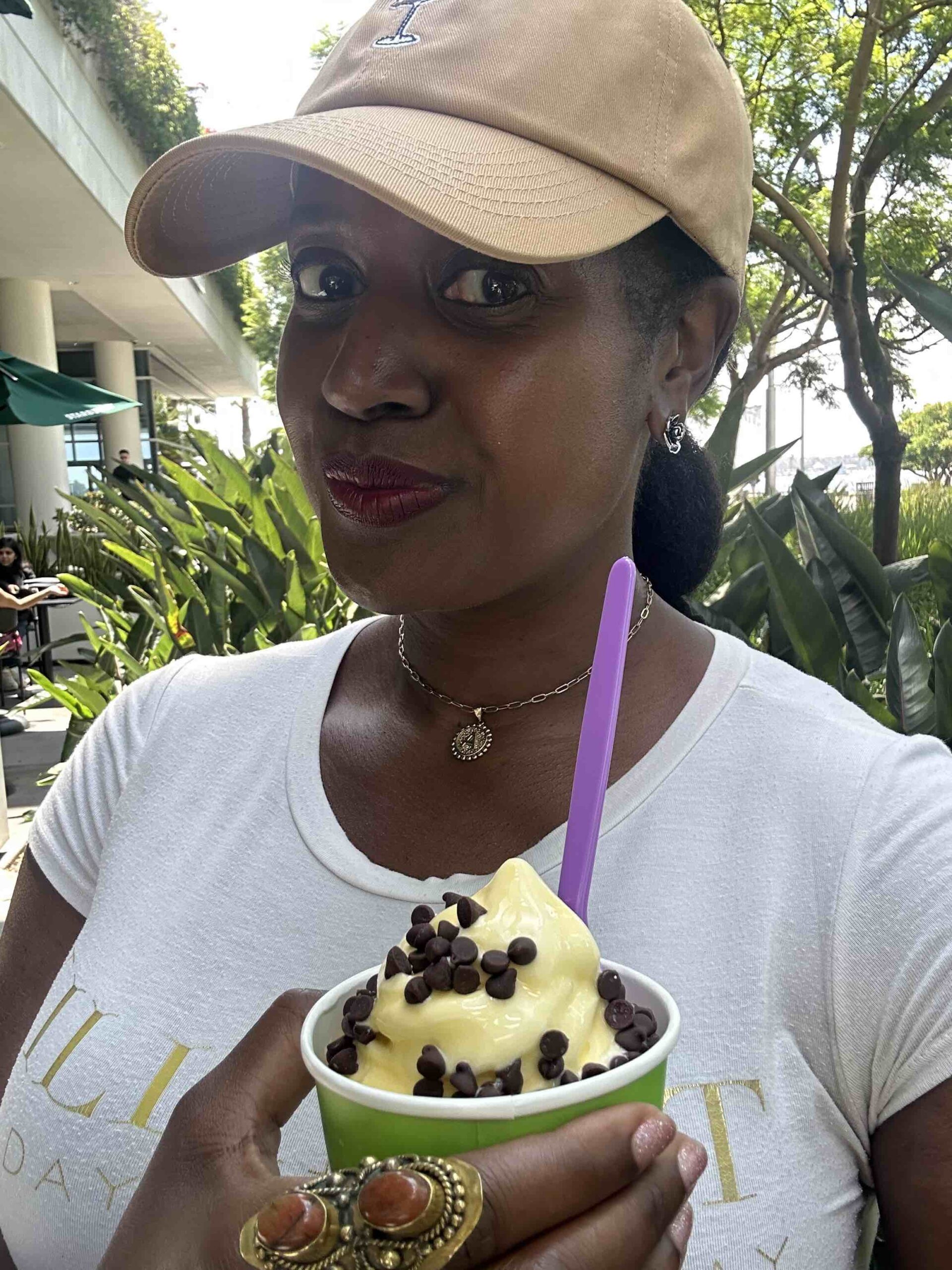 An image of lifestyle blogger Ariel holding a cup of froyo.