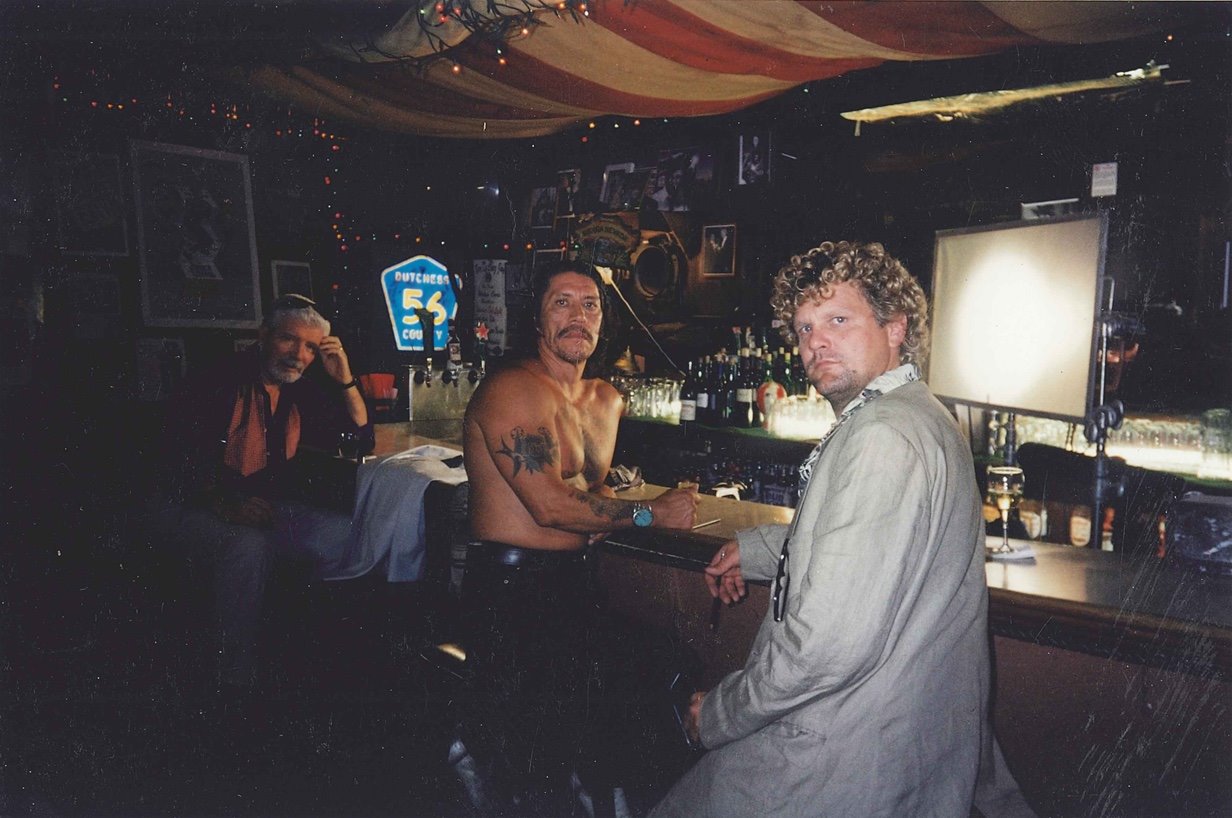 An image Danny Trejo and two others sitting at the bar at Chez Jay.