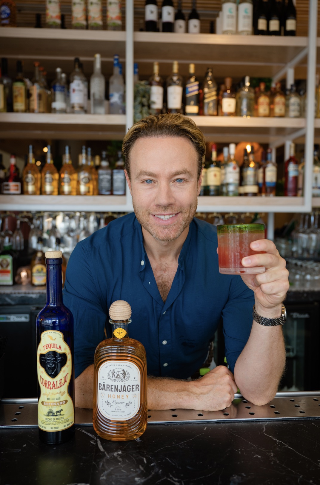 An image of cocktail guru Paul Zahn holding the Pomegranate Honey Margarita, available a La Nena Cantina.