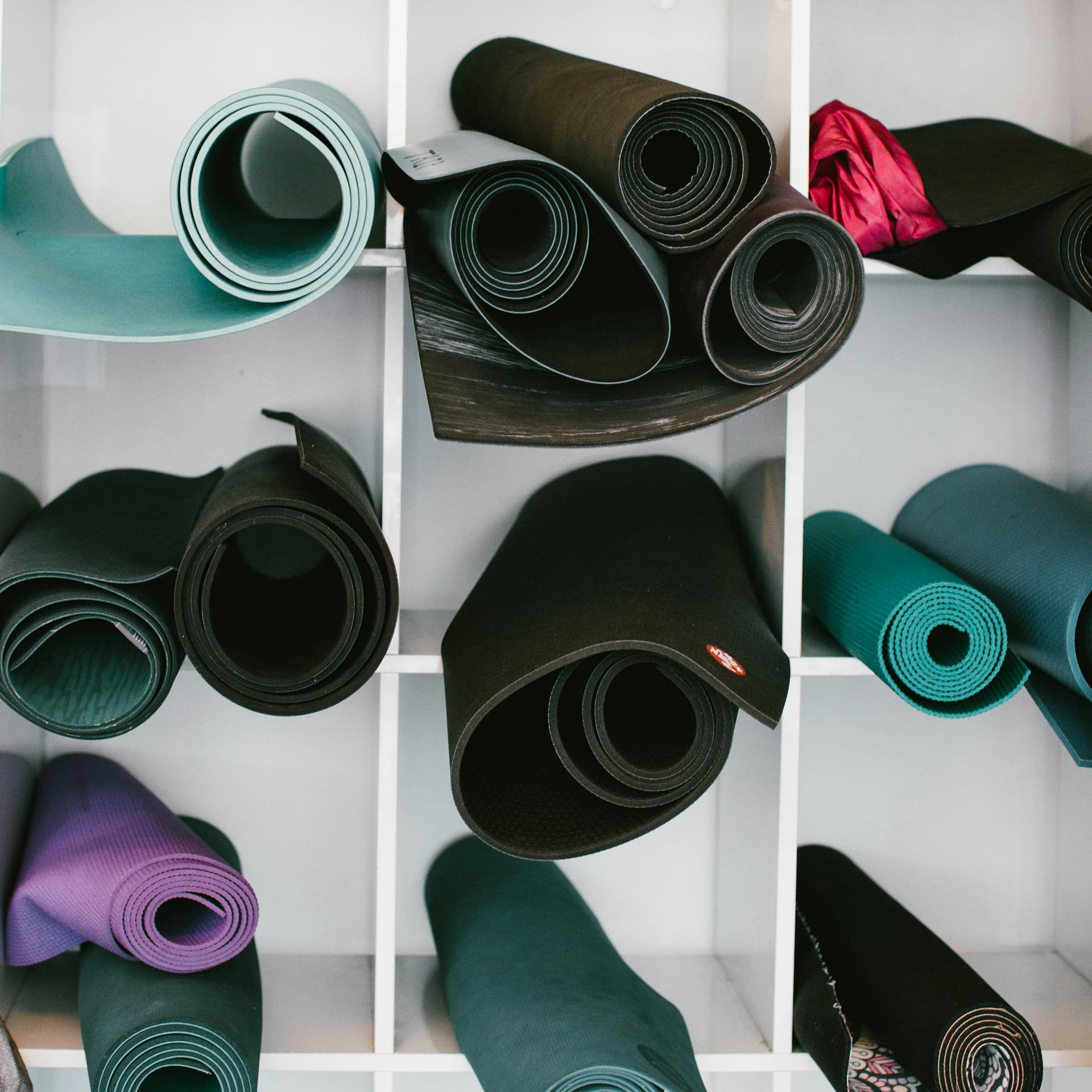 An image of a cabinet filled with yoga mats.