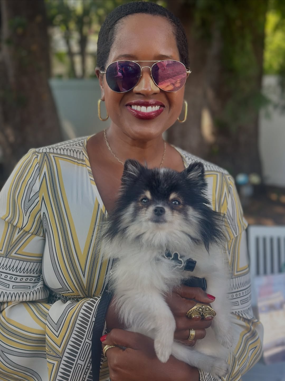An image of lifestyle blogger Ariel Johns holding a dog from Marley's Mutts dog adoption.