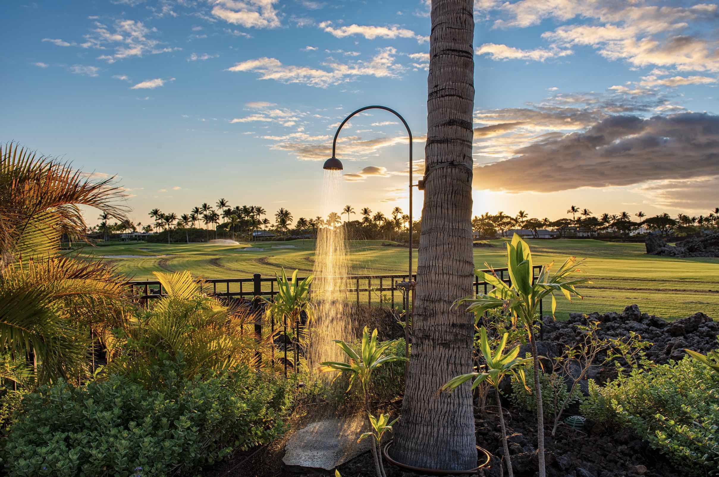 An image of a Hawaiian golf course with a beautiful outdoor shower.
