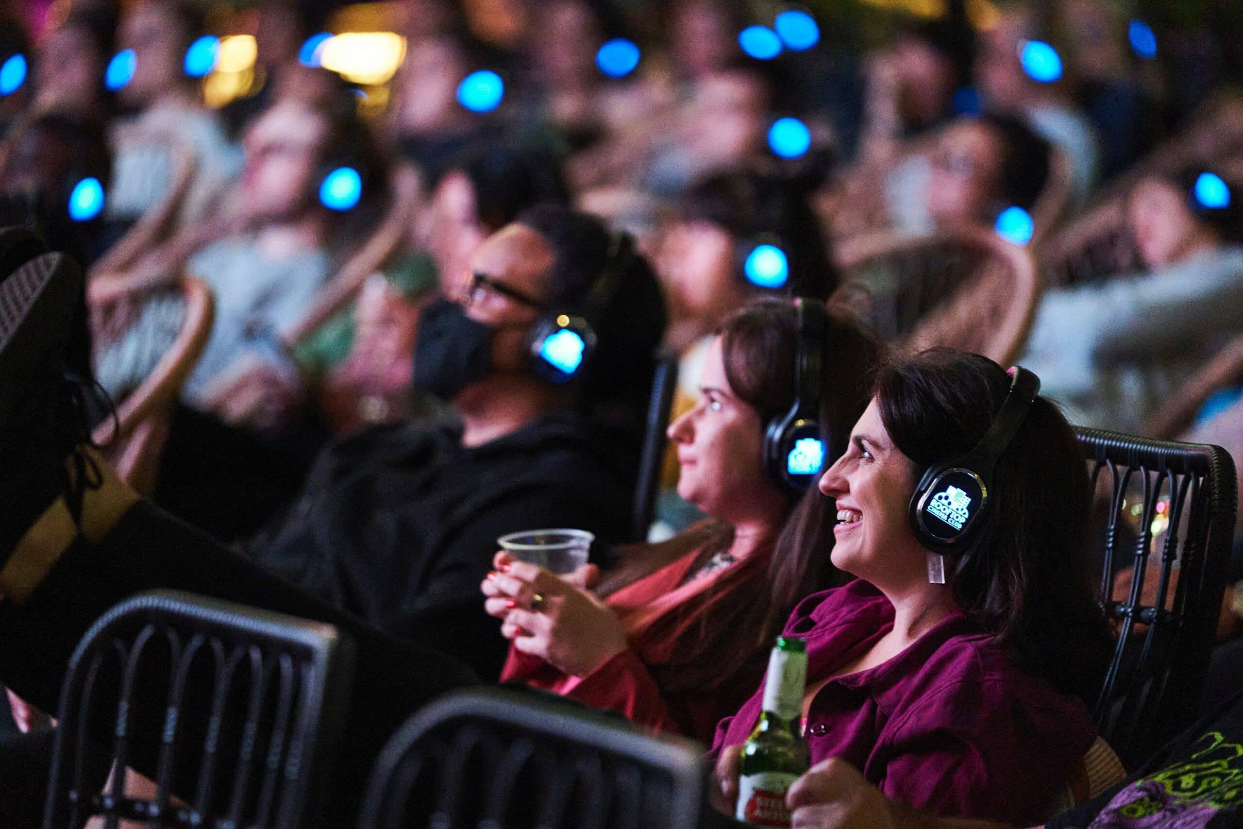 An image of a group of people watching a movie at Rooftop Cinema Club.