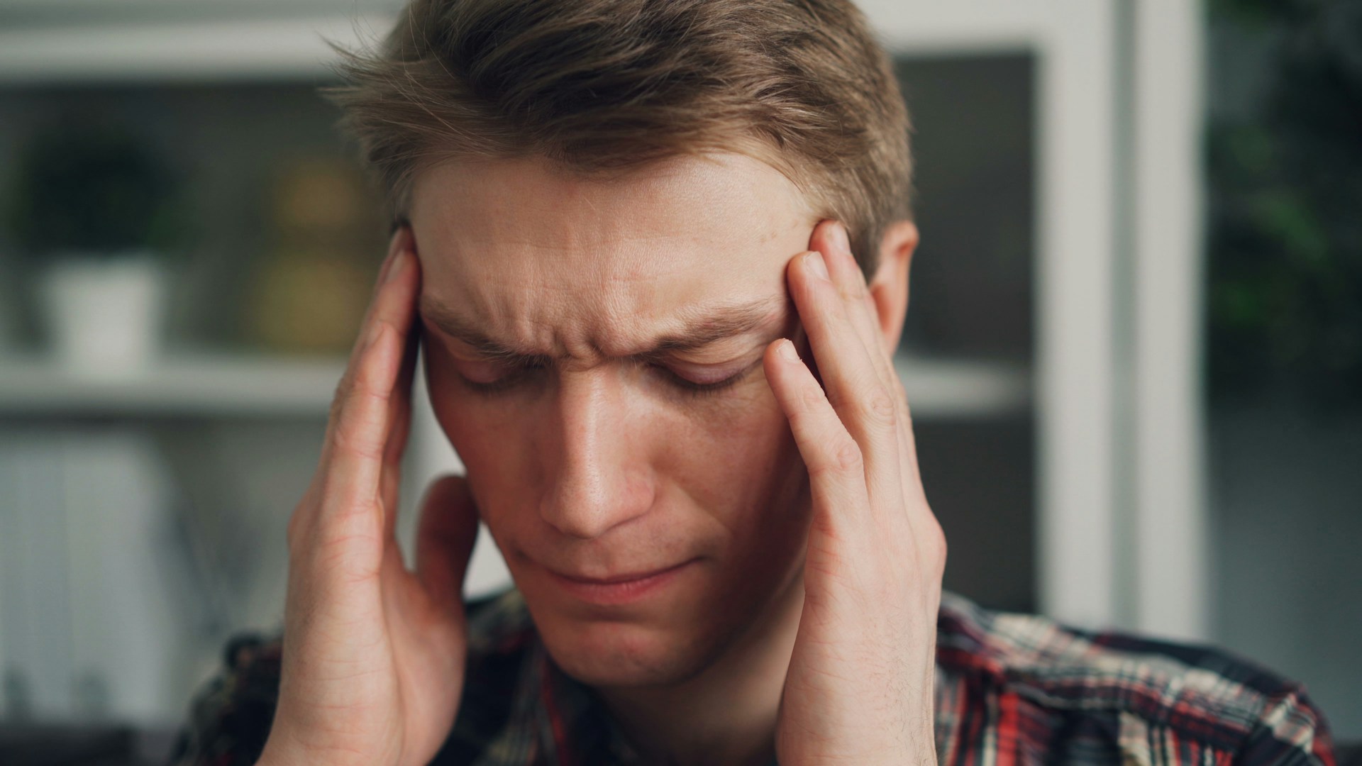 An image of a man with a headache.