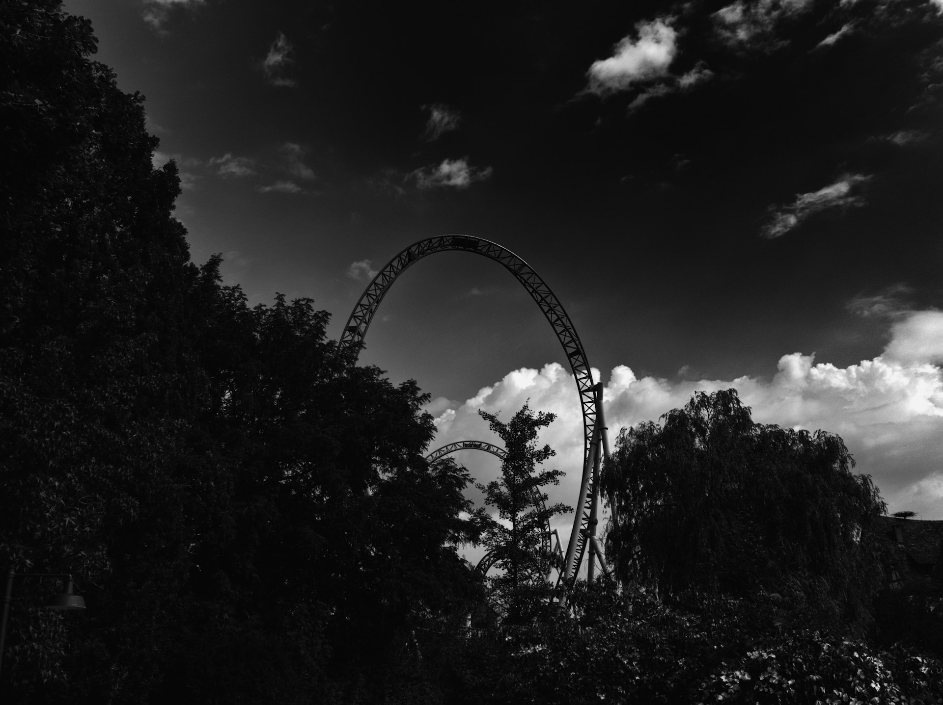 A black & white image of a roller coaster.