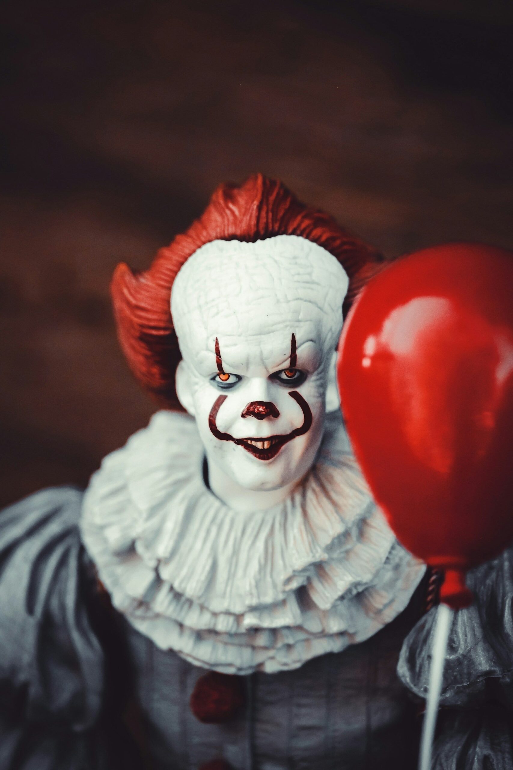 An image of someone dressed as Pennywise from It.