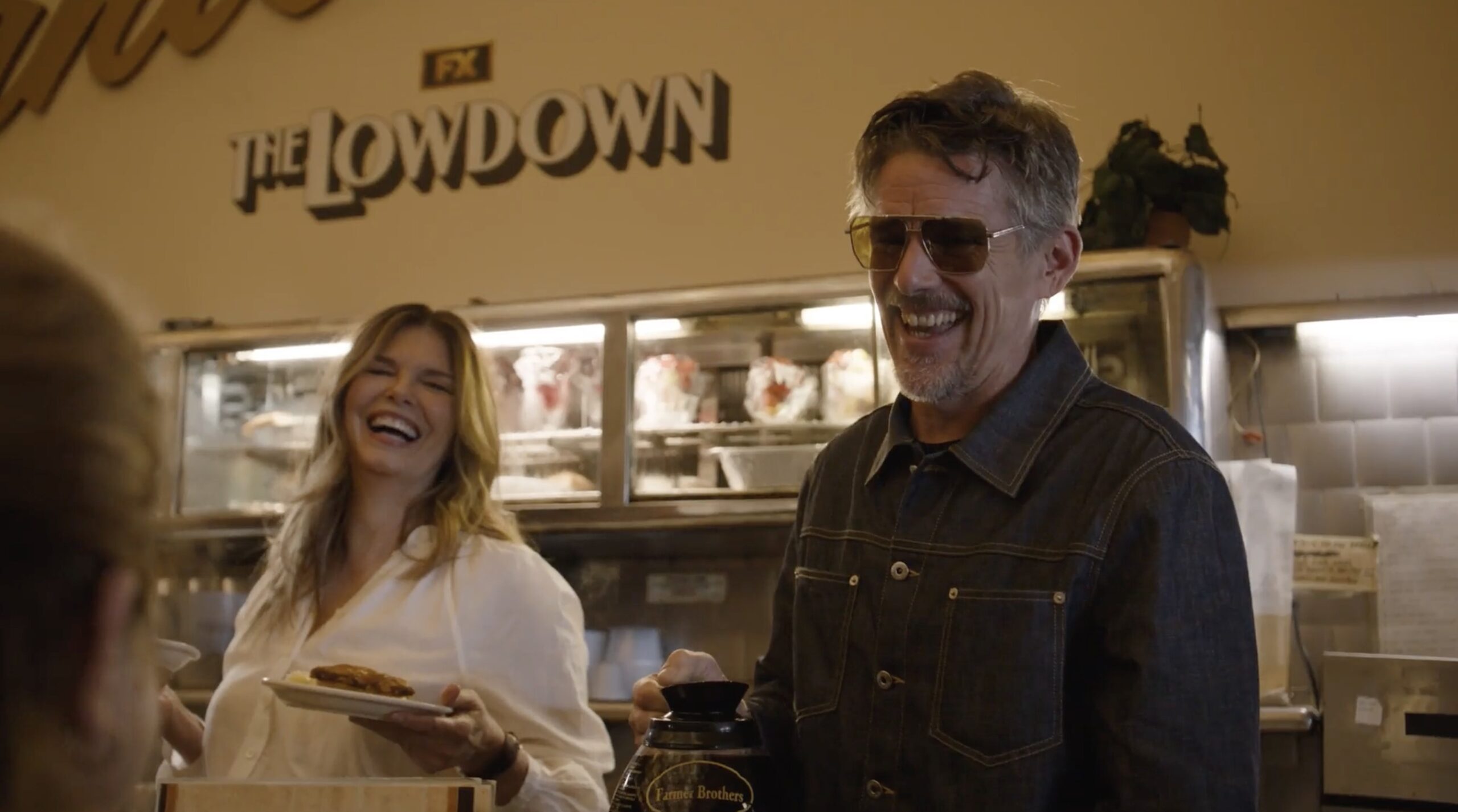 An image of Ethan Hawke and Jeanne Tripplehorn serving fans at The Lowdown's takeover of Canter's Deli.