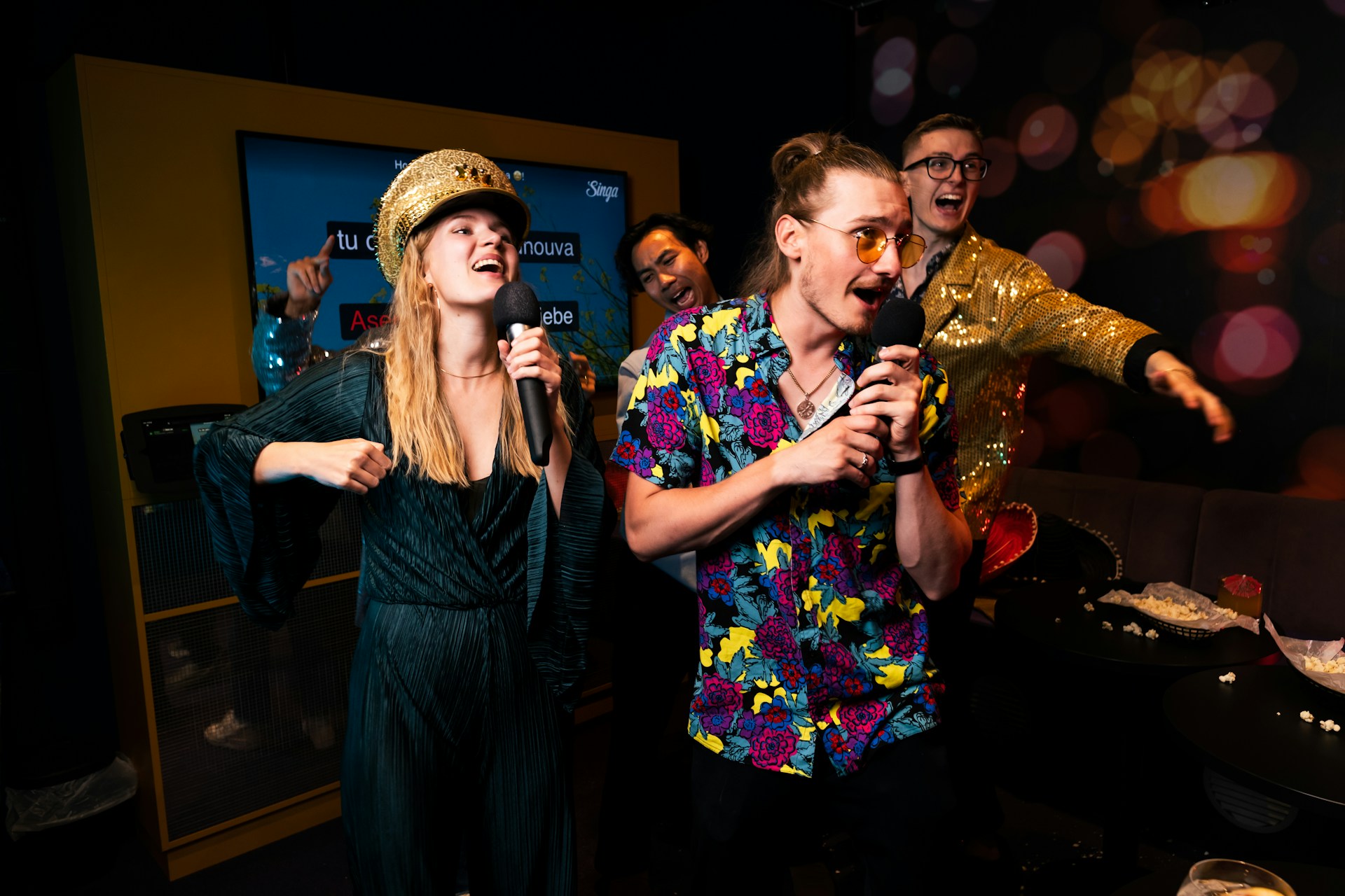 An image of 3 people singing karaoke.