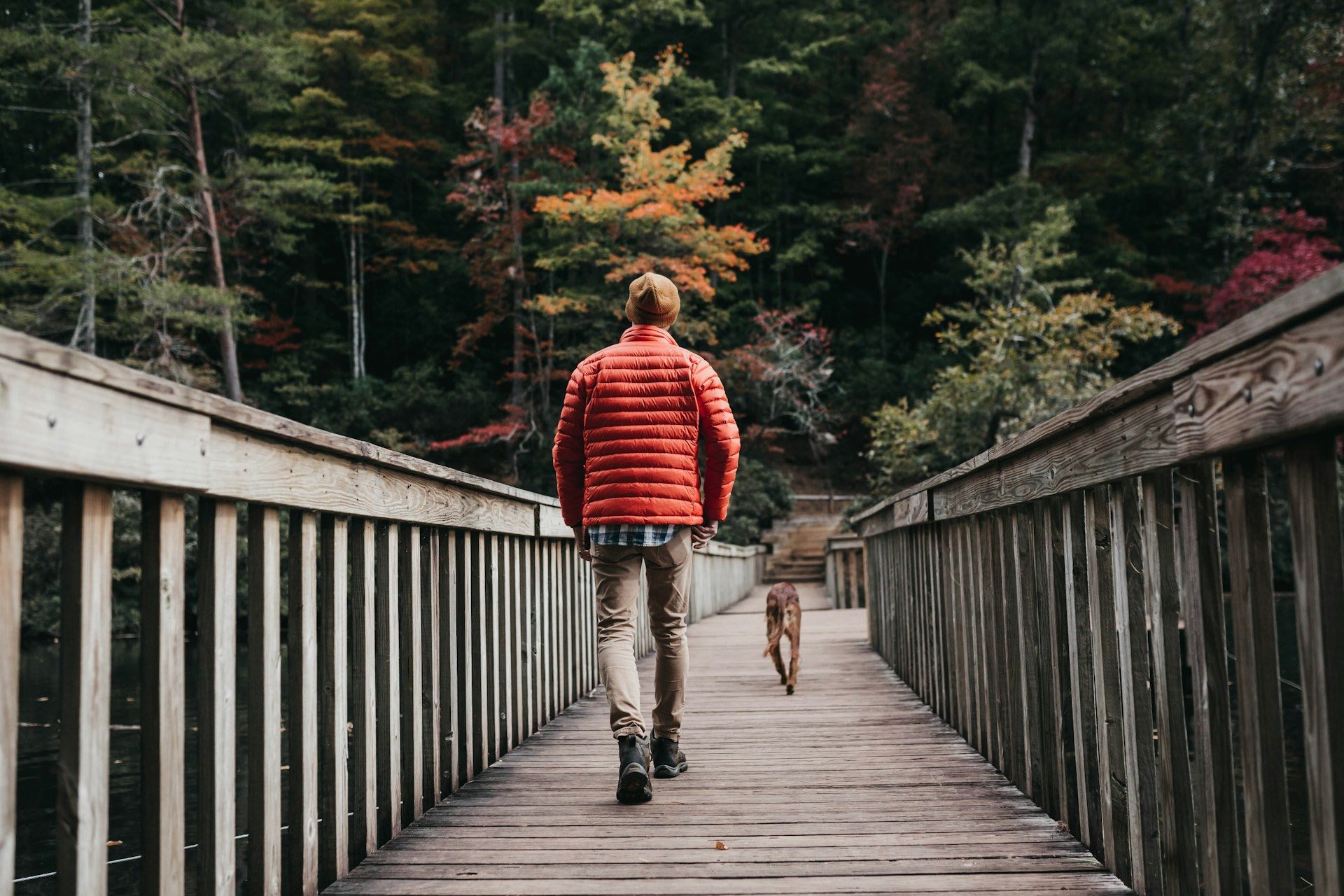 An image of a man walking his dog.