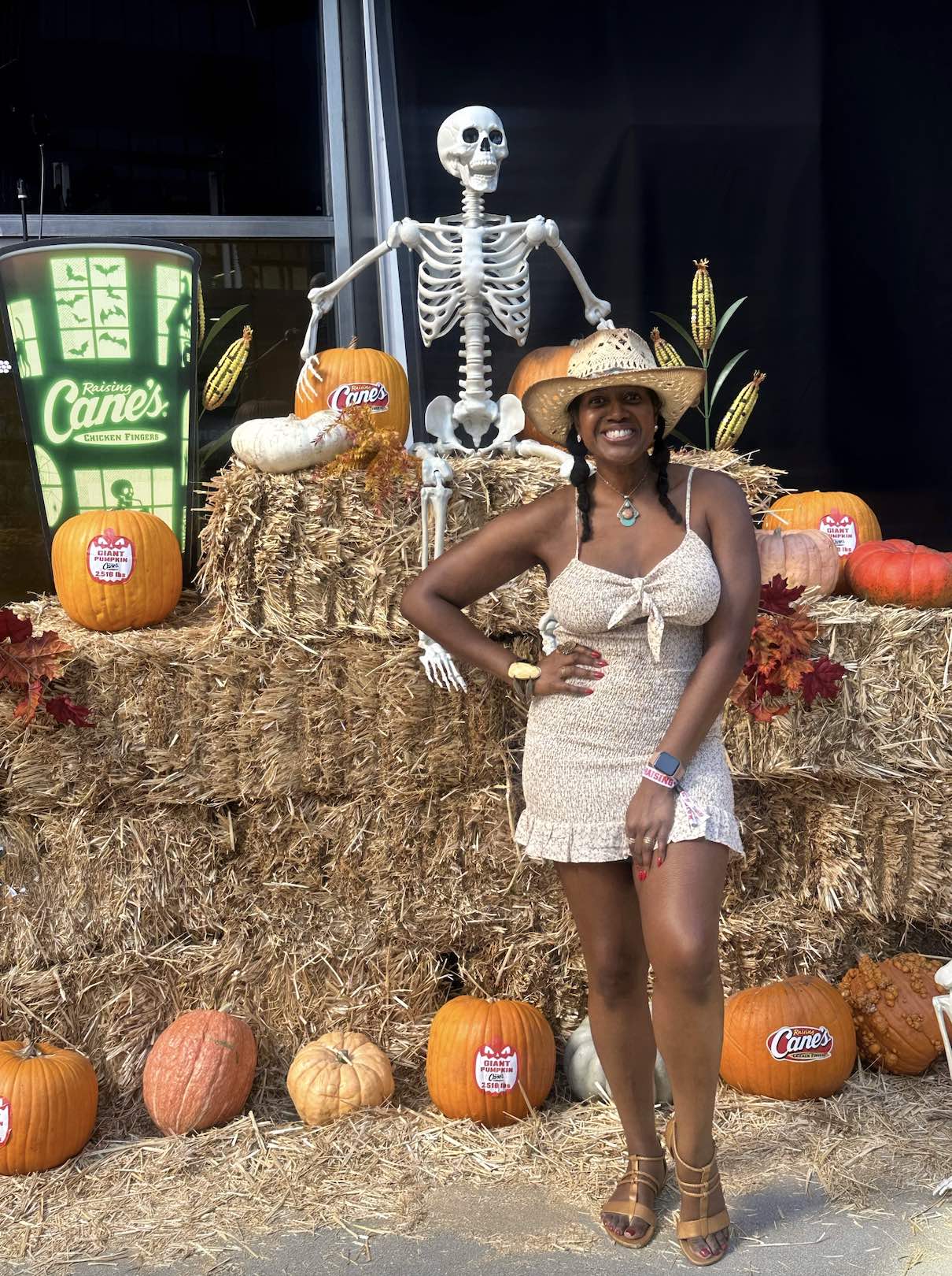 An image of lifestyle blogger Ariel Johns at Raising Cane's giant pumpkin unveiling.
