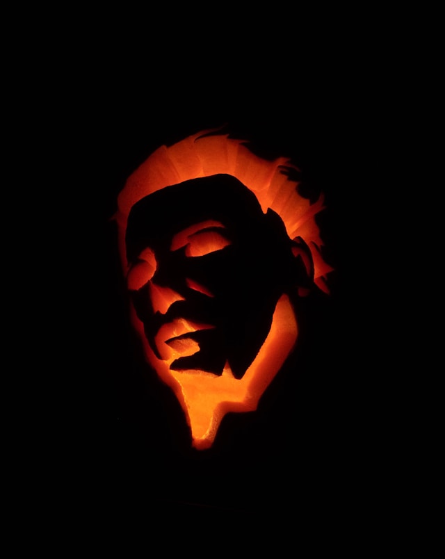 An image of a pumpkin carved with Michael Myers face.