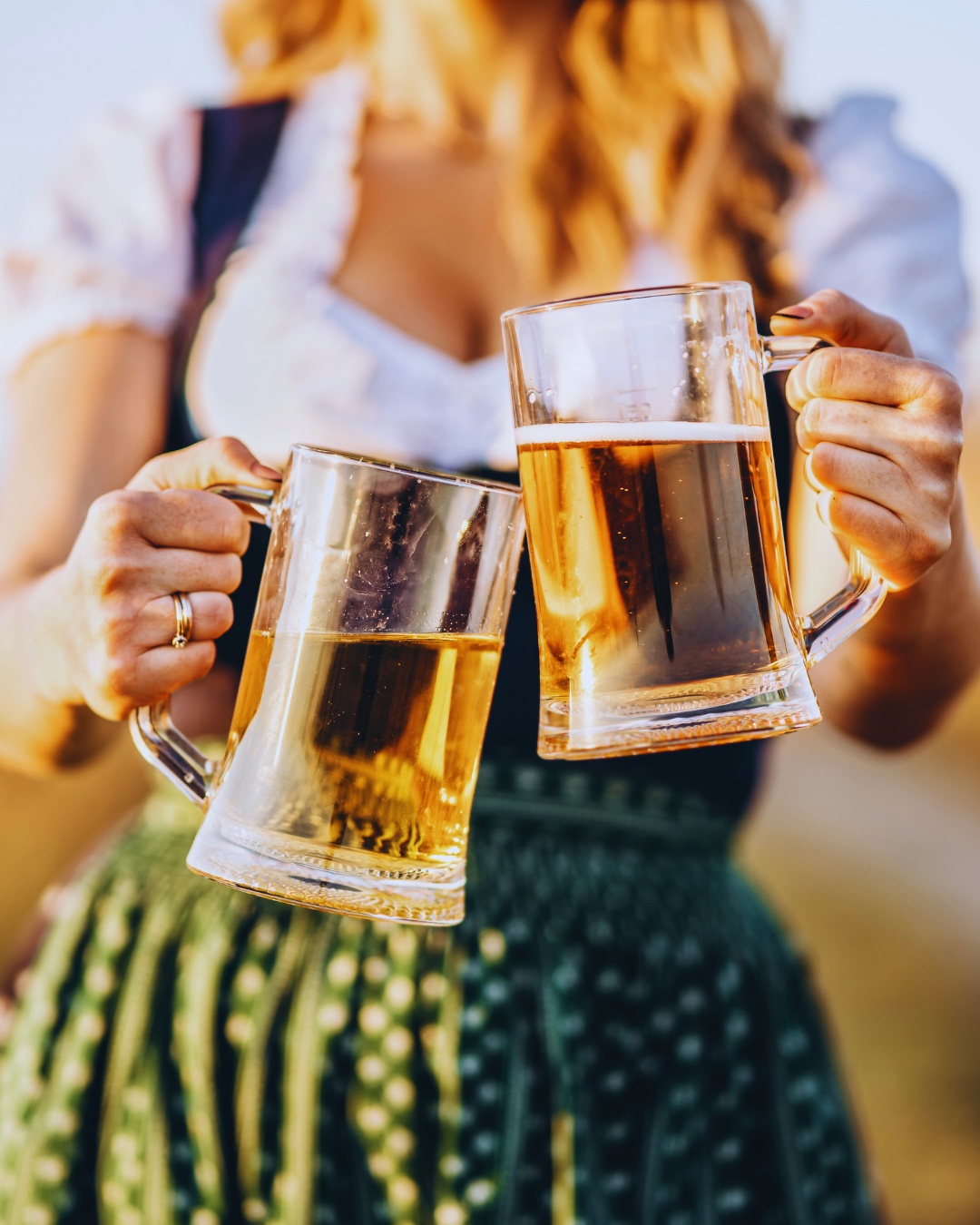 An image of a girl holding beer steins for Oktoberfest