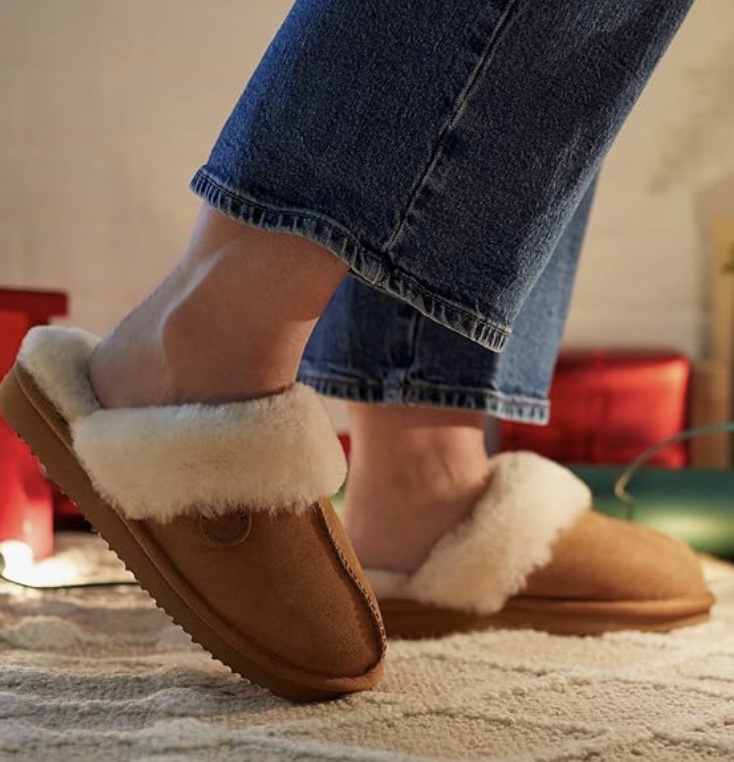 An image of a woman wearing Fireside by Dearfoams slippers.