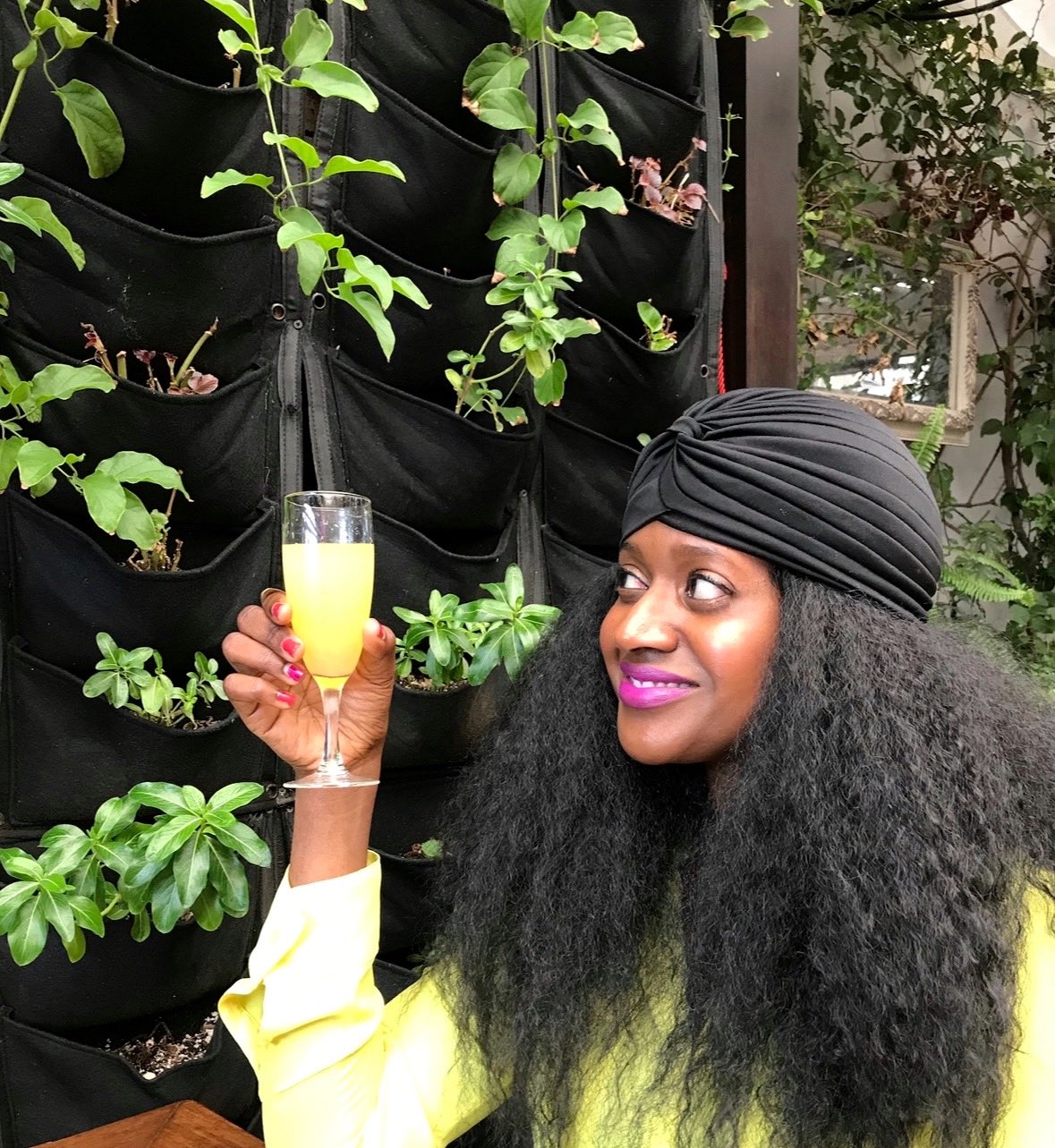 An image of lifestyle blogger Ariel holding a mimosa.
