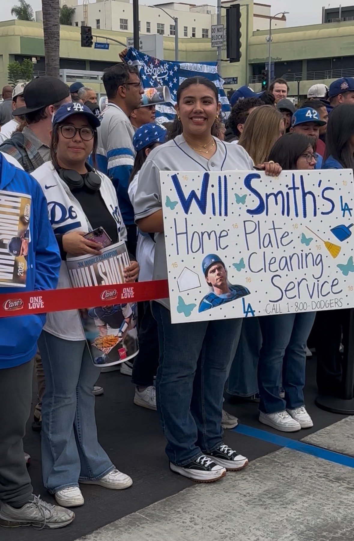 An image of a Dodgers fan holding a Will Smith sign.